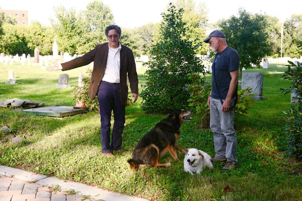 Guy Palace (left) with a Congressional Cemetery dog walker at the site of Charles Siegert's grave. Photo by Evy Mages.