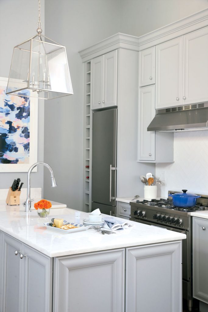 kitchens02-final - Washingtonian The Colonial-inspired, oversize pendant above the peninsula is from Restoration Hardware. Photo by Christopher Shane.