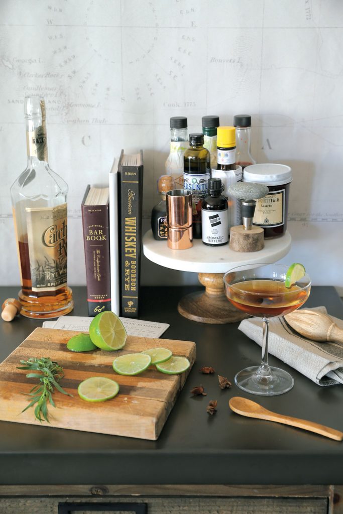 Olmstead displays her cocktail supplies on a long console table to better serve her guests. Photo by Christopher Shane.