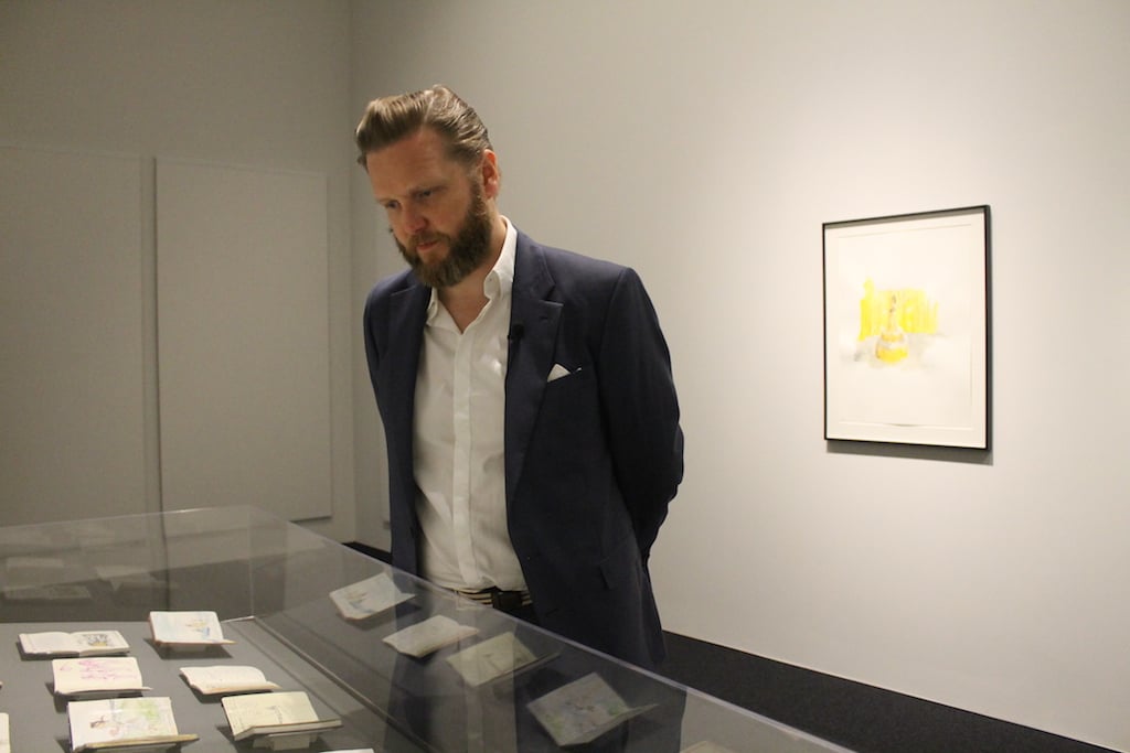 ragnar - Washingtonian Ragnar Kjartansson looking at his sketchbooks at the exhibition. Photo by Greta Weber.