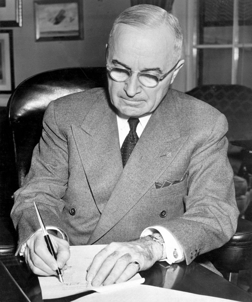 President Harry S. Truman signing a proclamation declaring a national emergency, December 16, 1950. Photo by Department of Defense \wikimediacommons