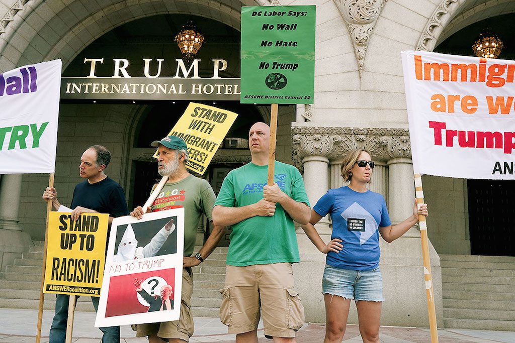 Protestors outside of the Trump Hotel. Photo by Getty Images. 