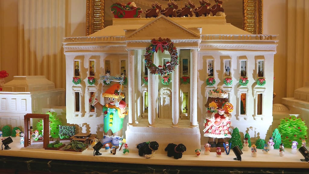 A mini White House made of gingerbread sits on the mantle of the State Dining Room.