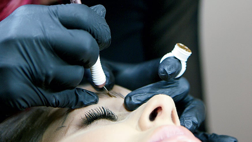 In tattooing, or microblading, pigment is applied using a handheld tool with small needles.