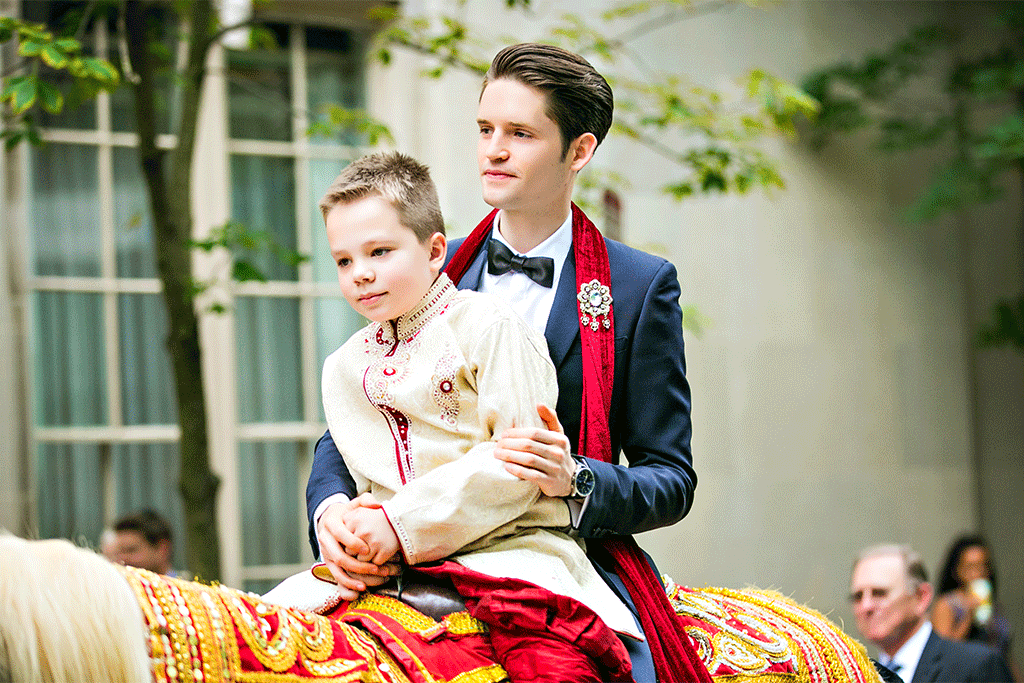 Interracial Indian wedding with groom on a horse