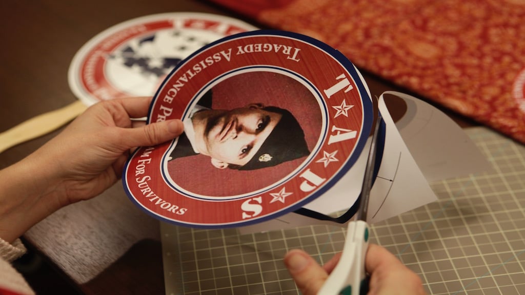 Seven volunteers assisted with the creation of the fans being used in the parade. Two out of the seven helped to cut out photos like the one pictured here.