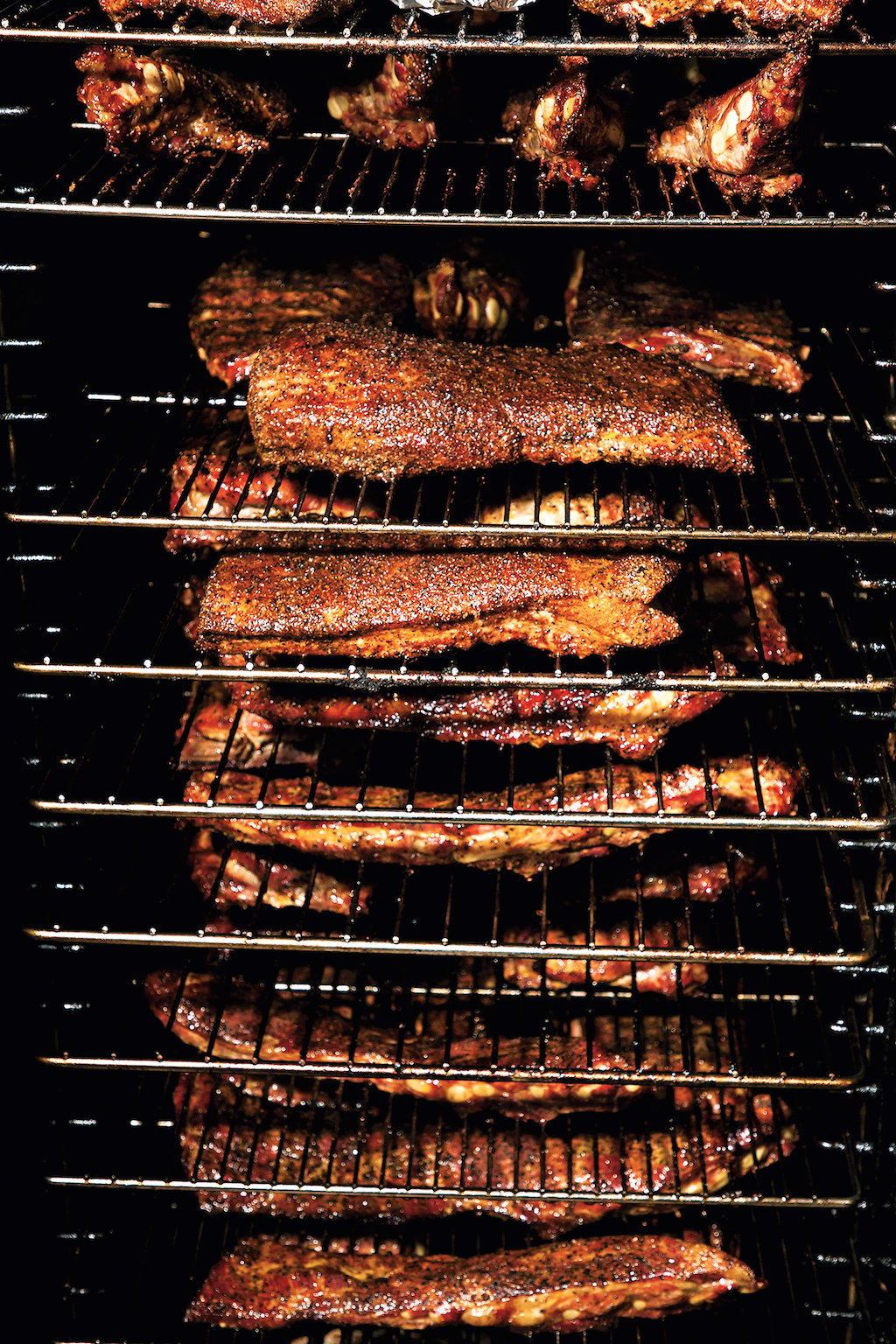 Ribs, sprayed in pickle brine, go into the smoker around noon.