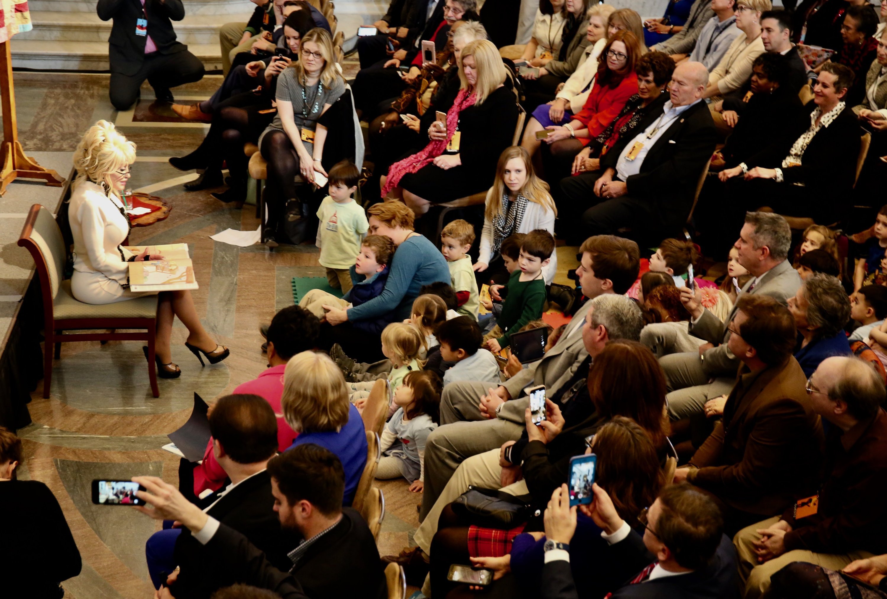 Parton reading to the children. Each child took home a free copy of "Coat of Many Colors" after the event.