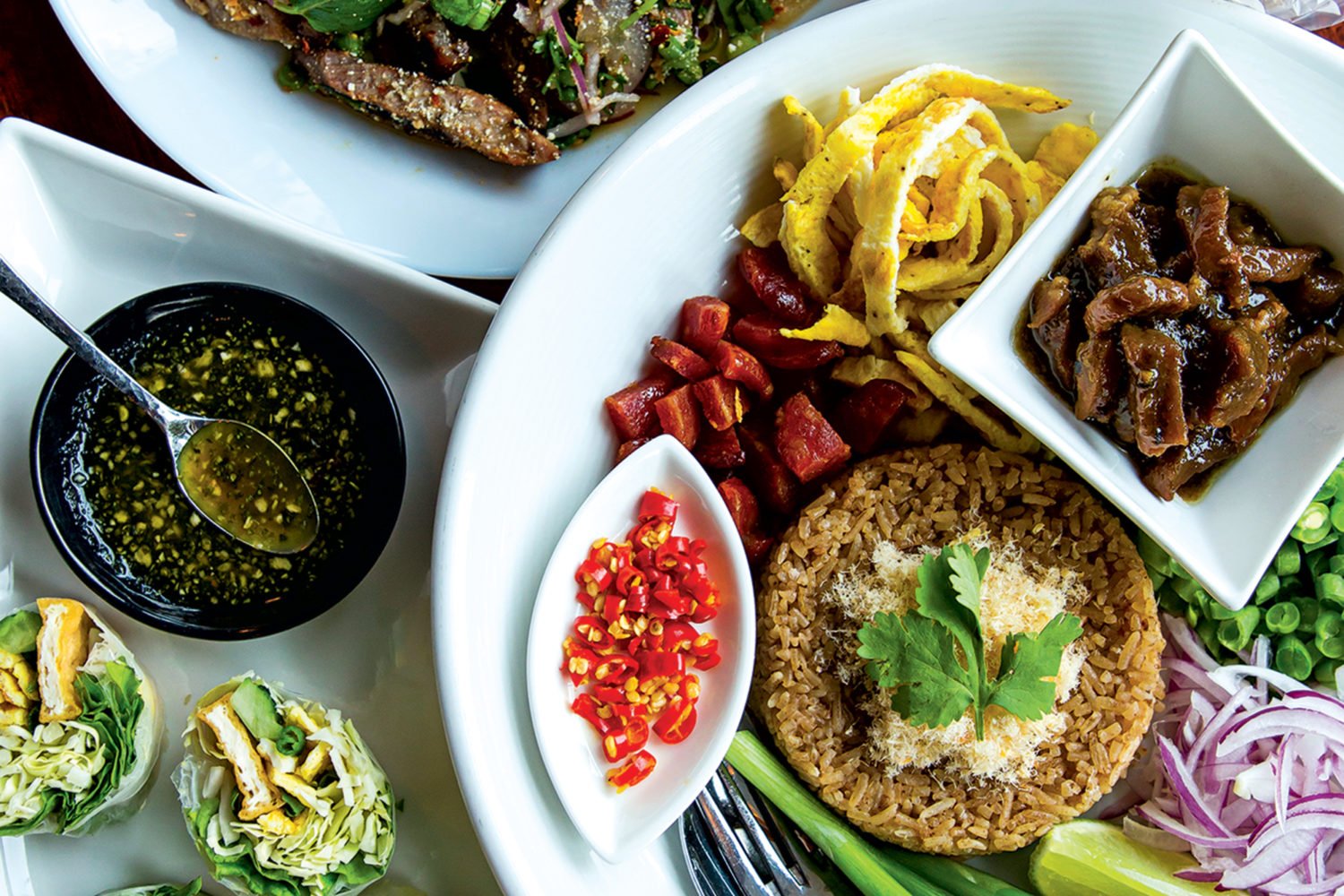 Basil-and-tofu rolls, Crying Tiger steak, and fried rice at Esaan. Photograph by Scott Suchman.