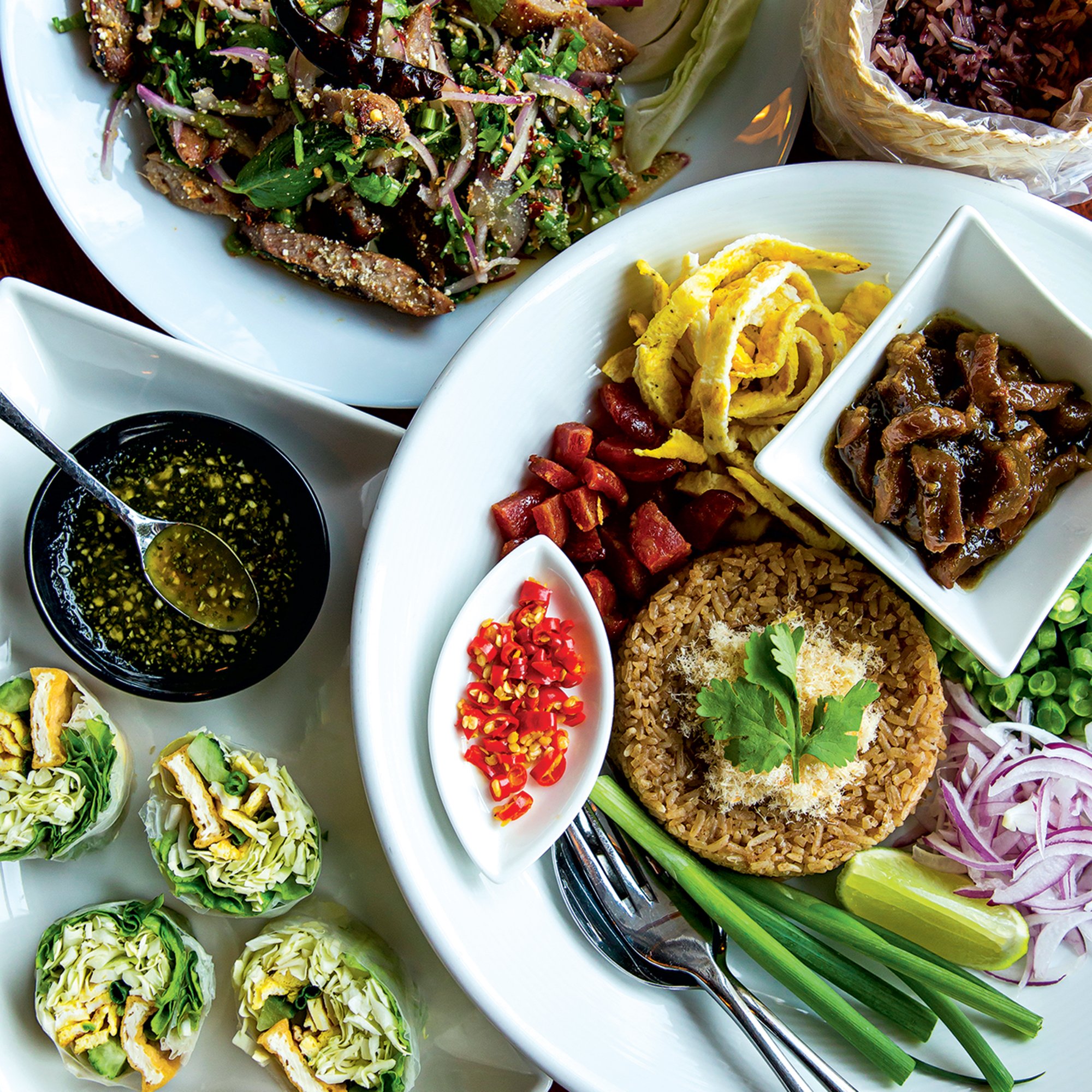 Basil-and-tofu rolls, Crying Tiger steak, and fried rice at Esaan. Photograph by Scott Suchman.