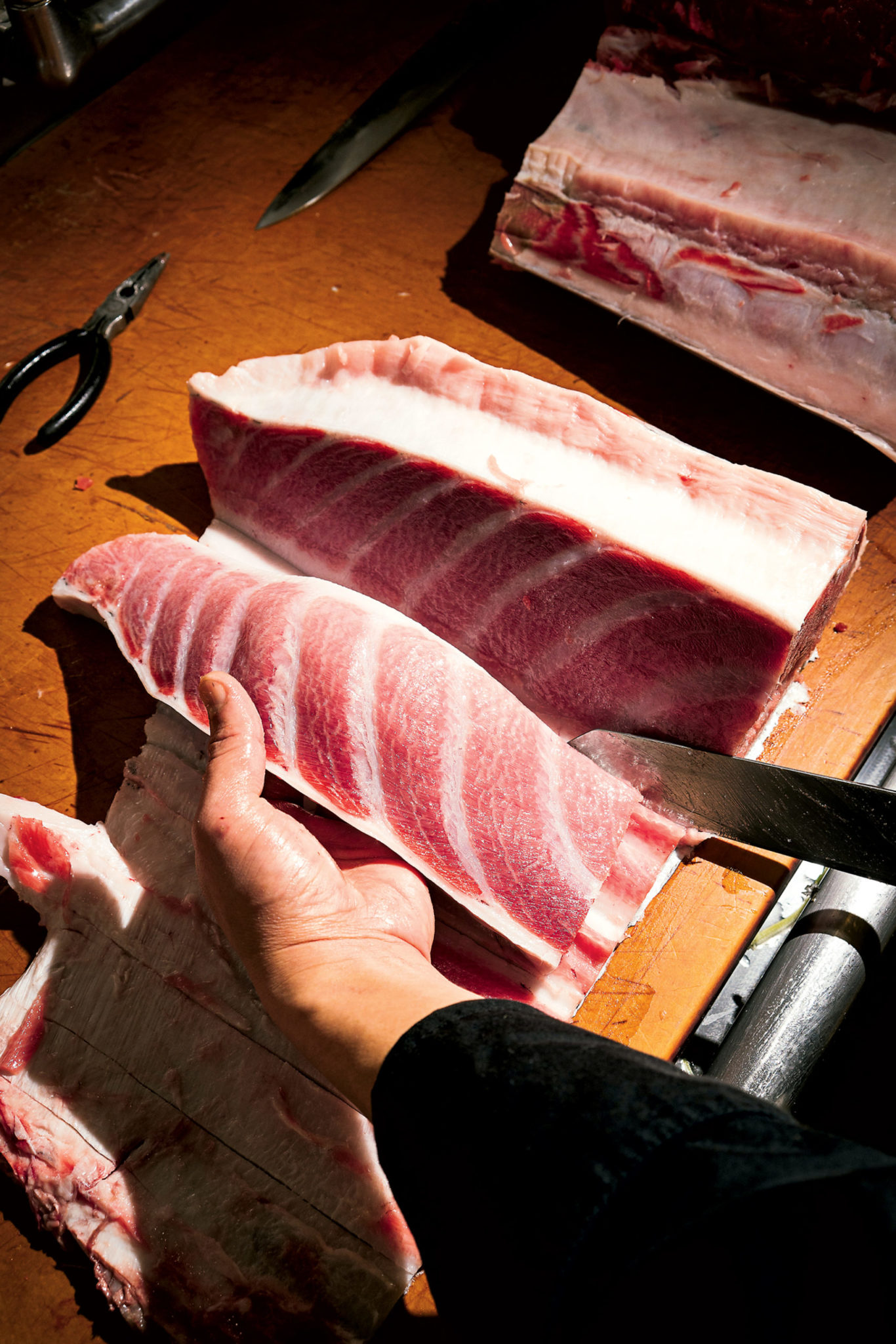 The brothers say some of the best bluefin tuna is farm-raised in Spain. And fresh isn't actually better – they dry-age the fish, like steak, for about ten days. Photograph by Scott Suchman.