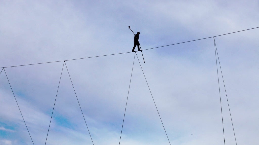 Nik Wallenda walks 75 feet off the ground in the National Harbor. Image by Evy Mages.