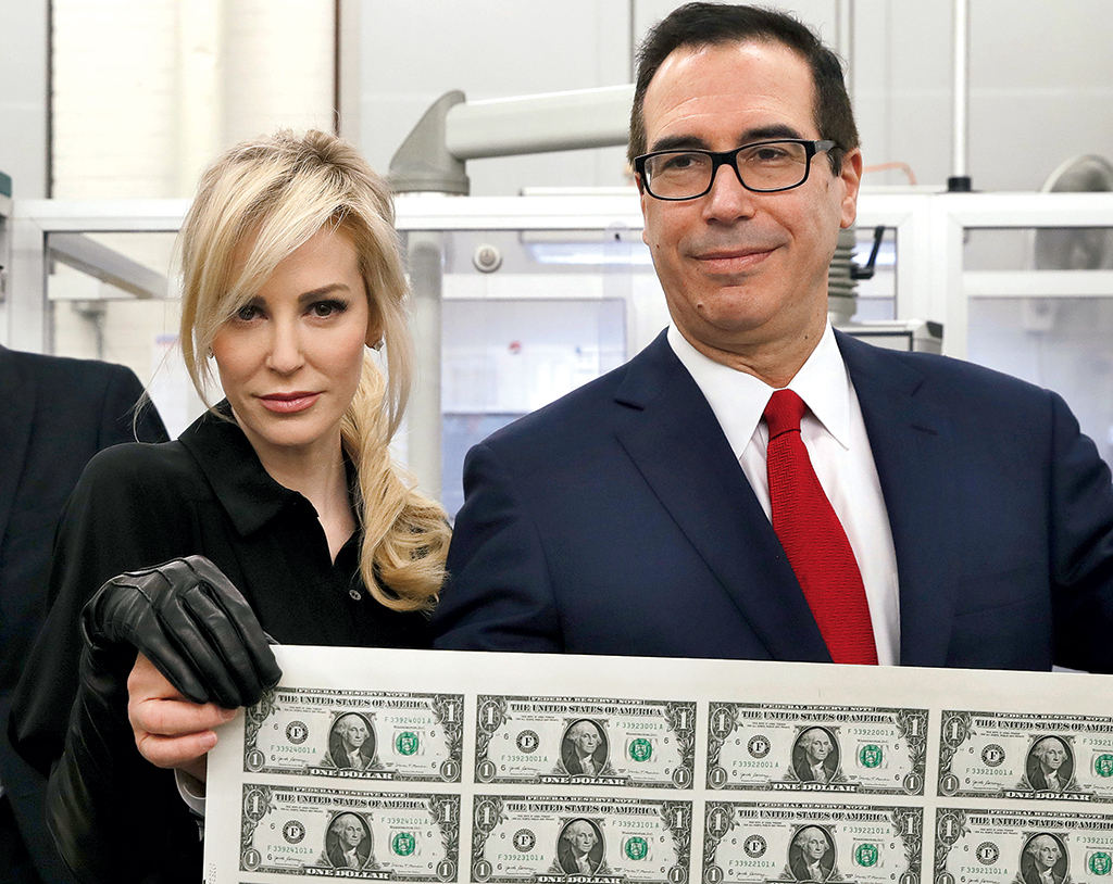 In the year since Steven Mnuchin joined the President’s Cabinet, Louise Linton has made numerous appearances at her husband’s office, which some Treasury employees found “disrespectful.” Critics pounced on this photo of the couple unveiling the new  alt=