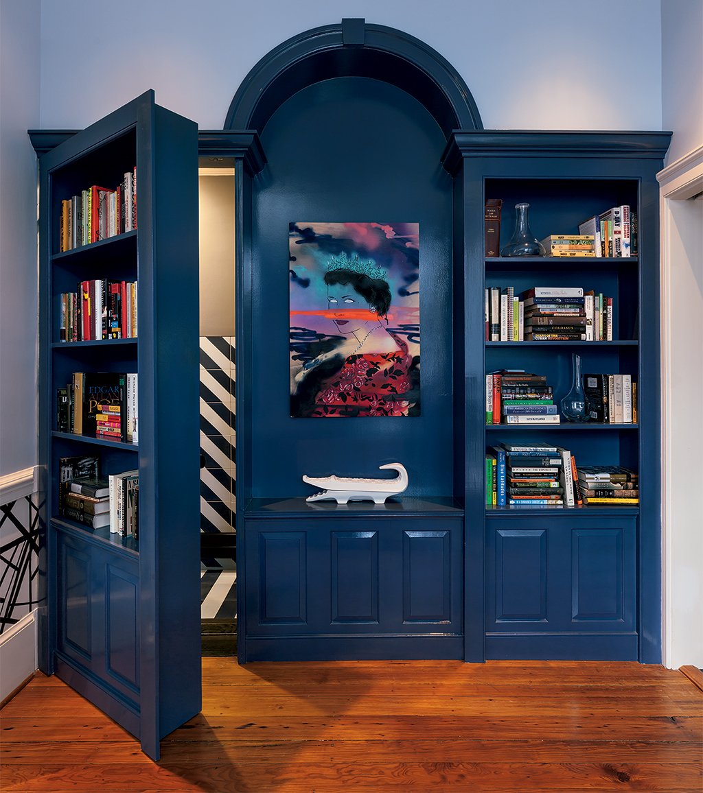 party4 - Washingtonian A panel of built-in shelving in the dining room doubles as a door that hides the powder room. Photograph by Mark Luthringer.