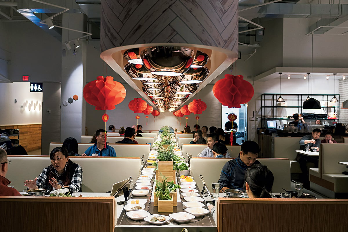 Hot-pot add-ins are offered on a conveyer belt. Photograph by Scott Suchman.