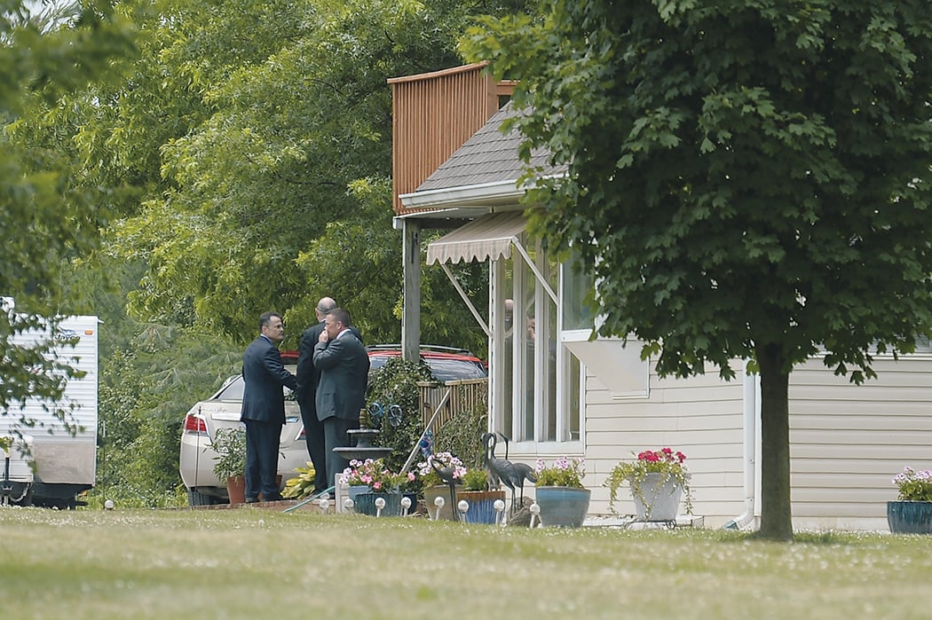 Investigators combed Hodgkinson’s home near St. Louis. Photograph of investigators by Michael B. Thomas/Getty Images.