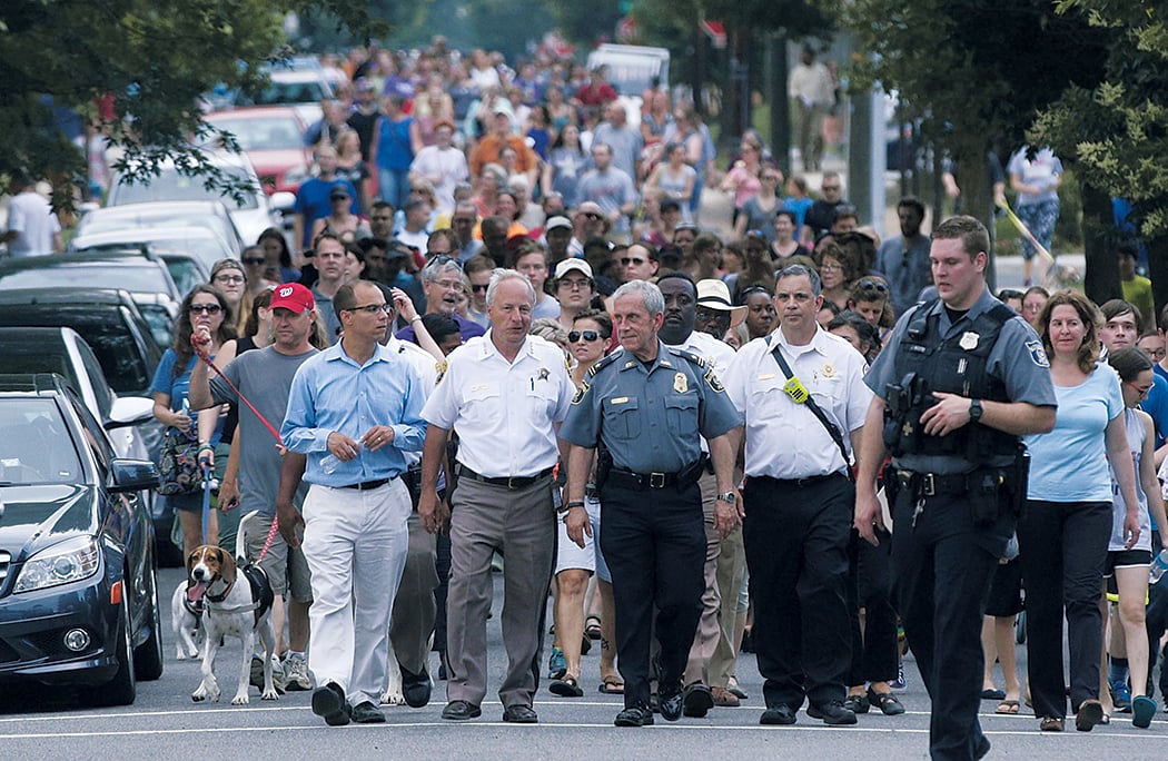 B12 - Washingtonian Alexandria residents staged an impromptu solidarity walk to a local church. Photograph of by Tom Williams/CQ Roll Call.
