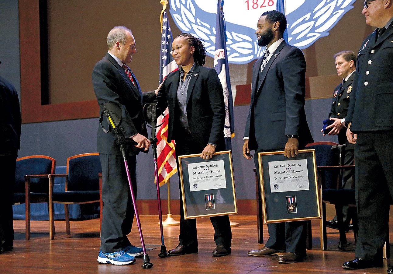 Scalise at a ceremony with Crystal Griner and David Bailey, the agents who saved his life. Photograph Reuters/Kevin Lamarque.