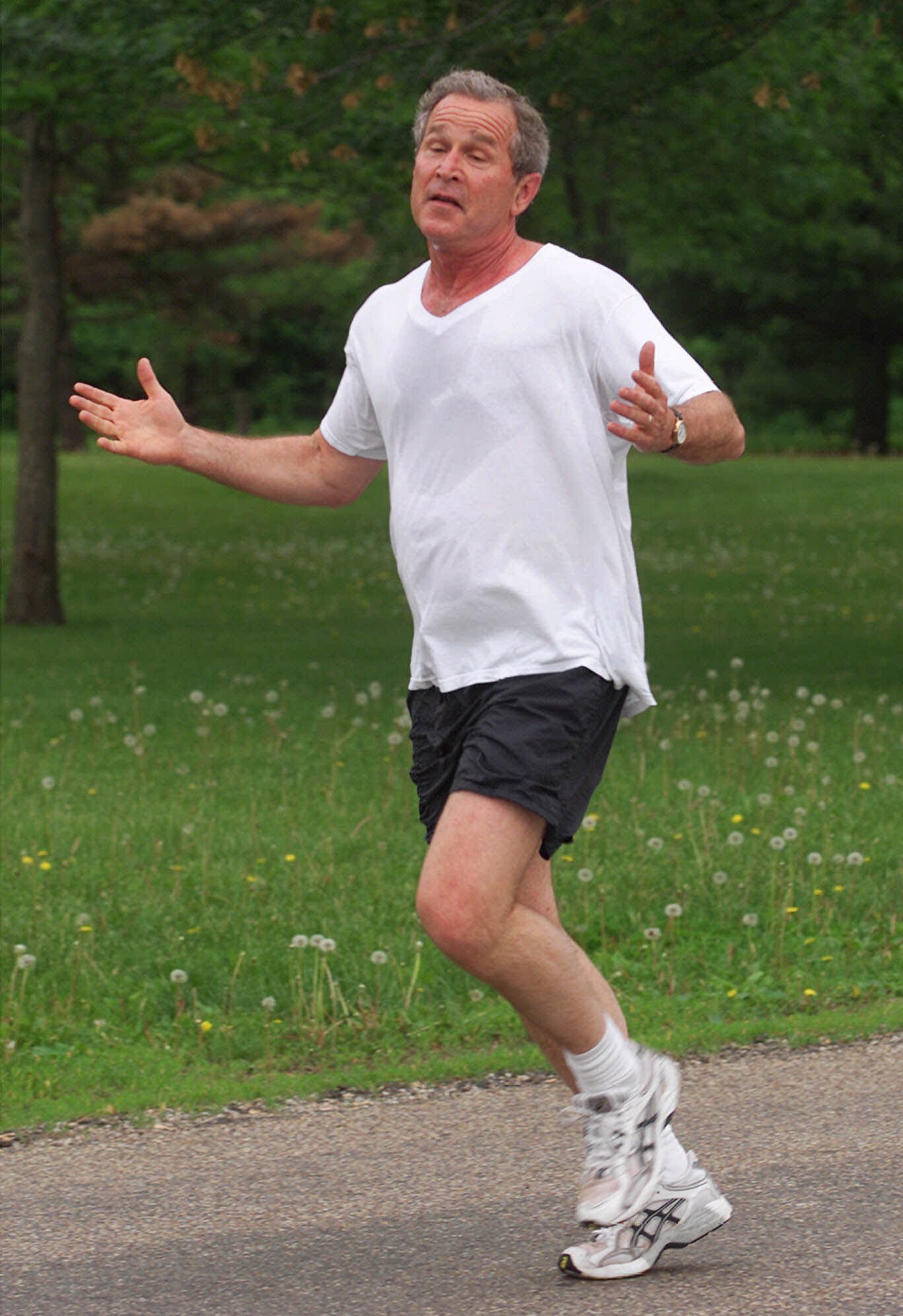 President Bush jogs in Water Works Park in Des Moines, Iowa, in 2001. Photograph by AP Photo/Ron Edmonds.