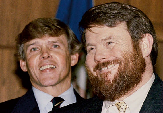 Brian Howard (left) and James Lowe (right), defense attorneys for Lorena Bobbitt, smile as they talk to reporters about the verdict in her malicious wounding trial. Photograph by J.DAVID AKE/AFP/Getty Images.