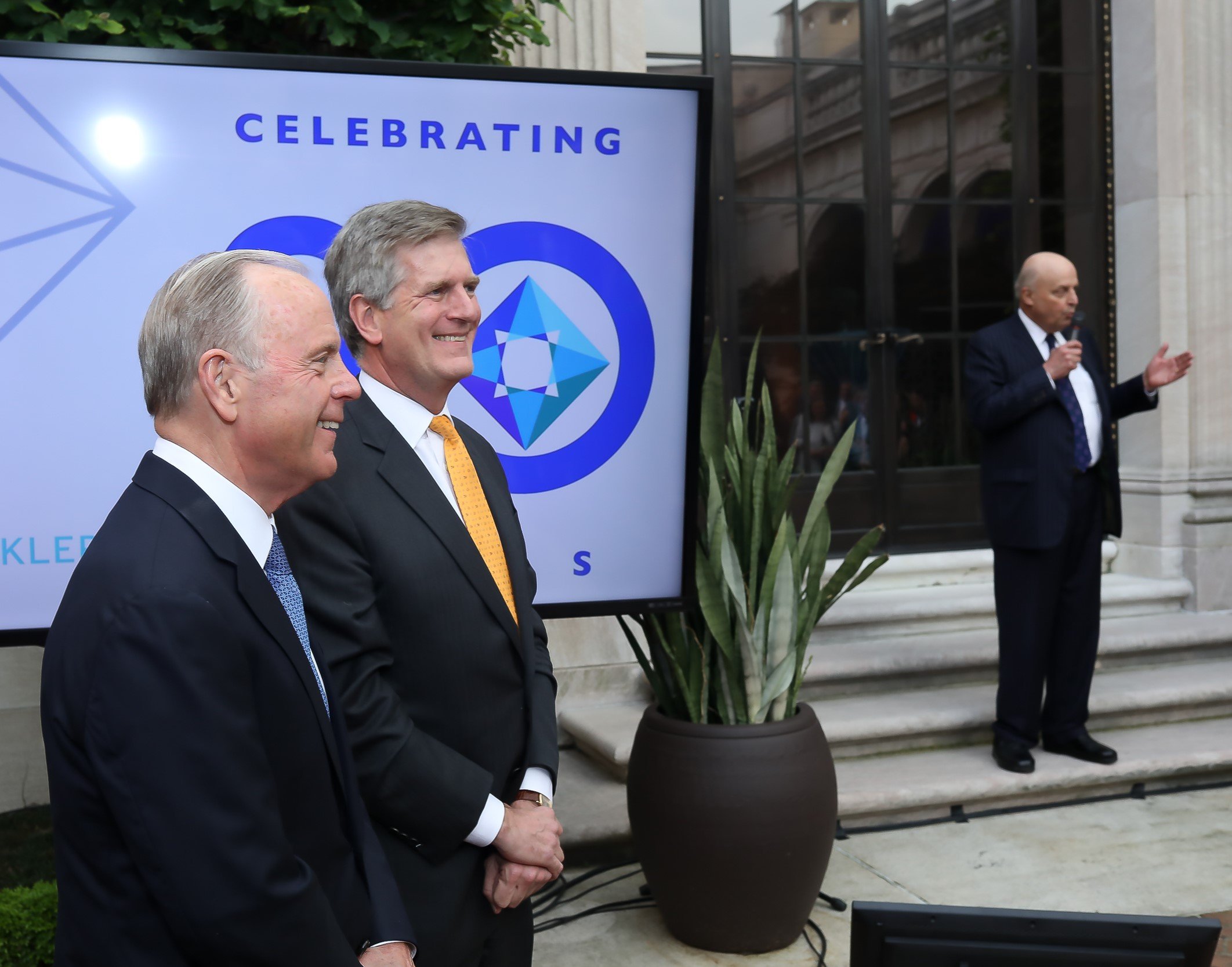 McLarty Associates leadership Mack McLarty and Nelson W. Cunningham smiling during Amb. John D. Negroponte’s remarks.