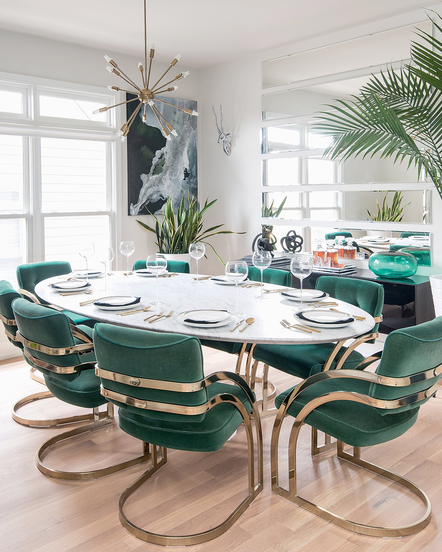  The green velvet dining chairs by Milo Baughman, top, were a bargain on eBay, while Metzler scored the marble tabletop on clearance at Restoration Hardware. 