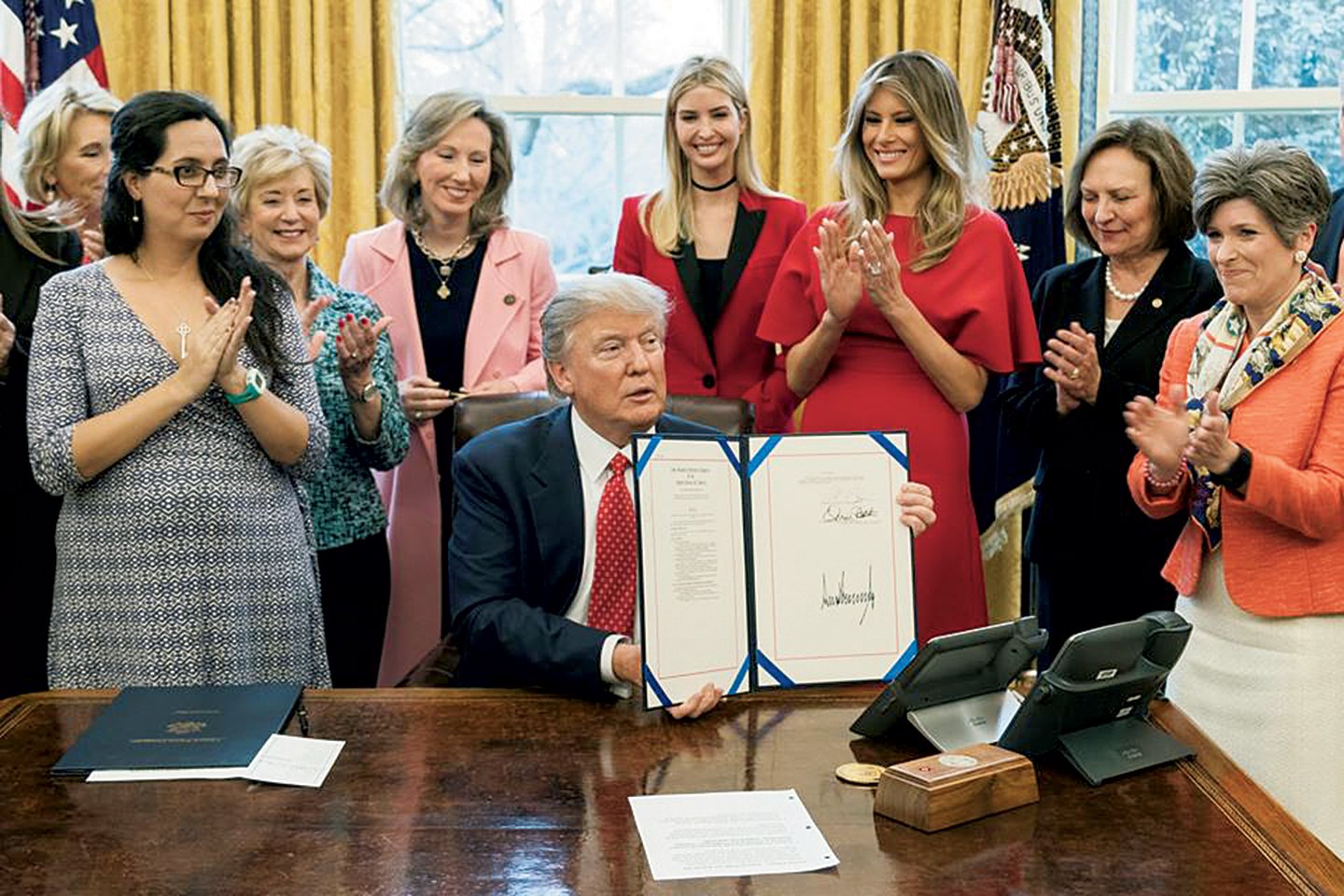 By 2017, Comstock avoided President Trump’s own conspiracy theories, instead appearing with him at less polarizing events, such as the signing of the INSPIRE Women Act. Photograph by Shealah Craighead.