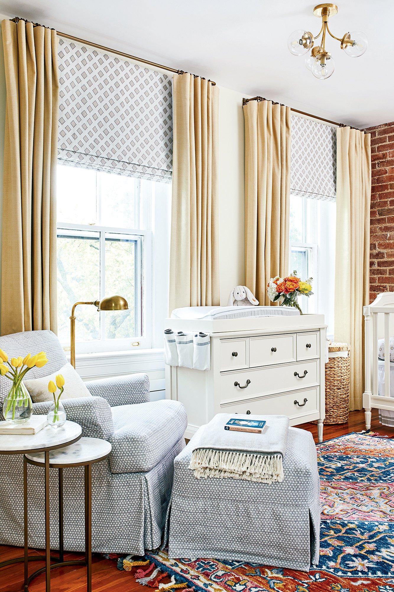 The old master bathroom became this soothing nursery, done up in tans and grays, with a jolt of color from the area rug by Zola. Photograph by Stacy Zarin Goldberg. 