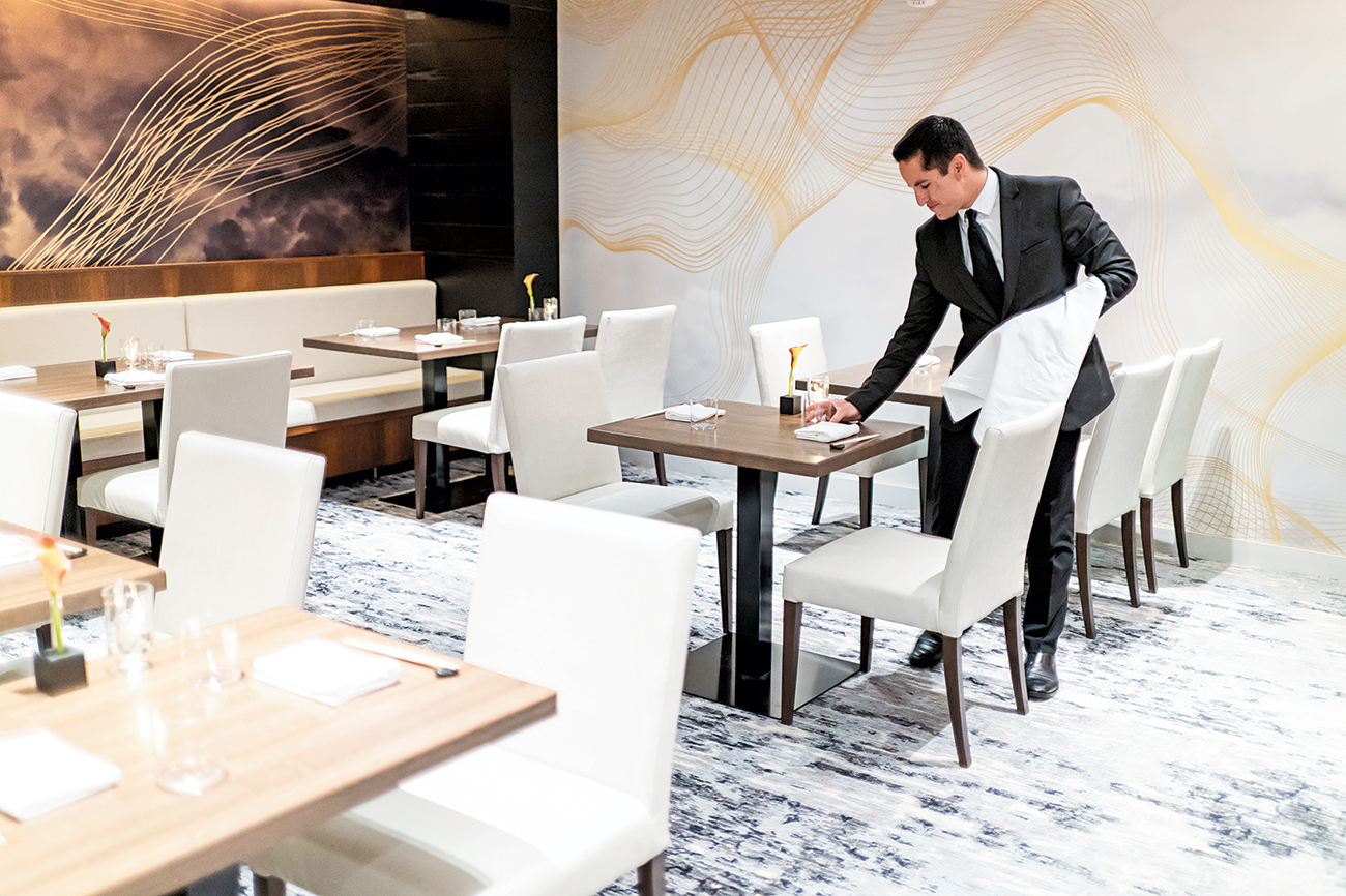 A server readies the dining room.