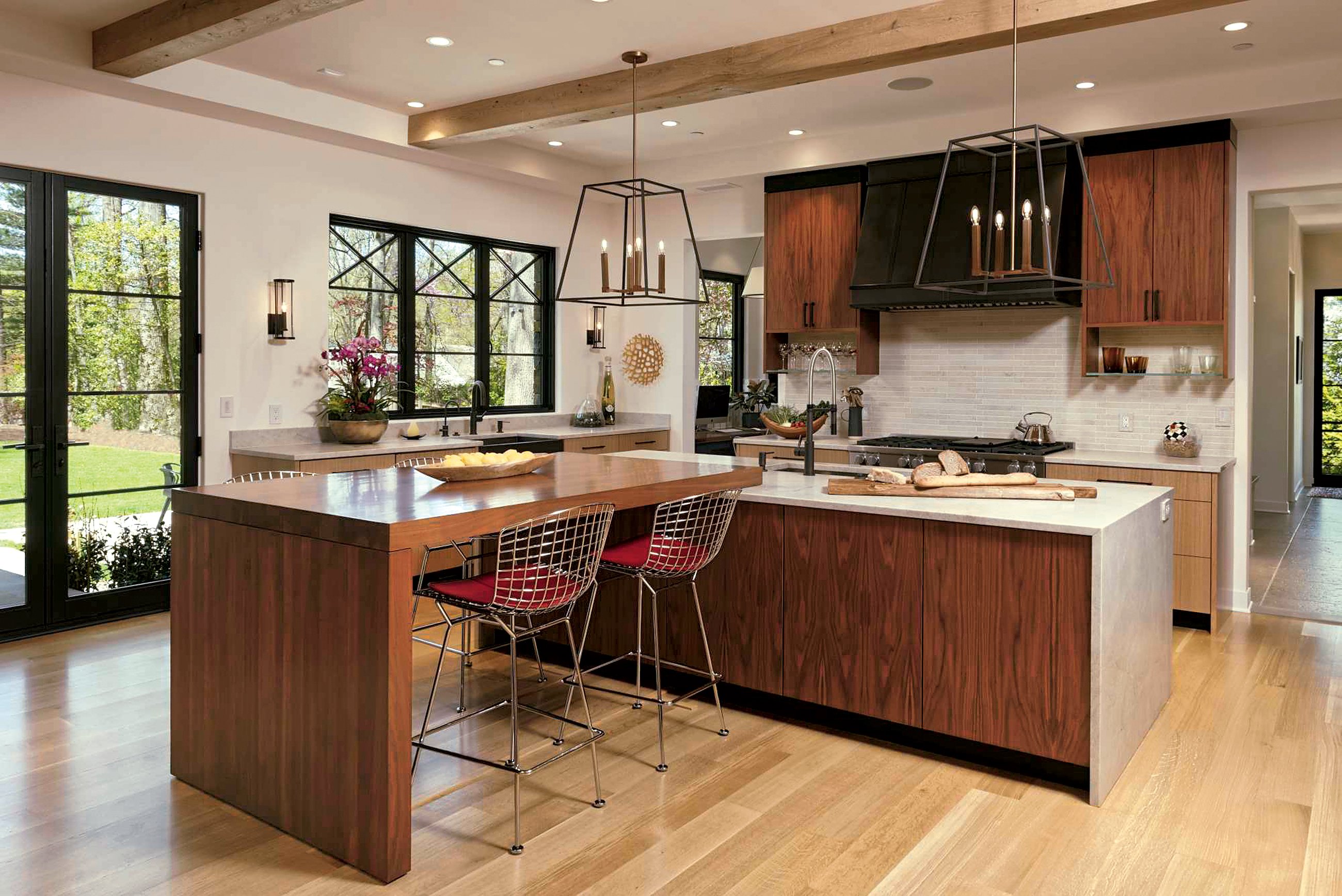 Quartzite countertops in a leather finish add rugged texture. The walnut and oak cabinetry is by Heartwood Design in Afton, Virginia. Photograph by Bob Narod/GTM Architects.