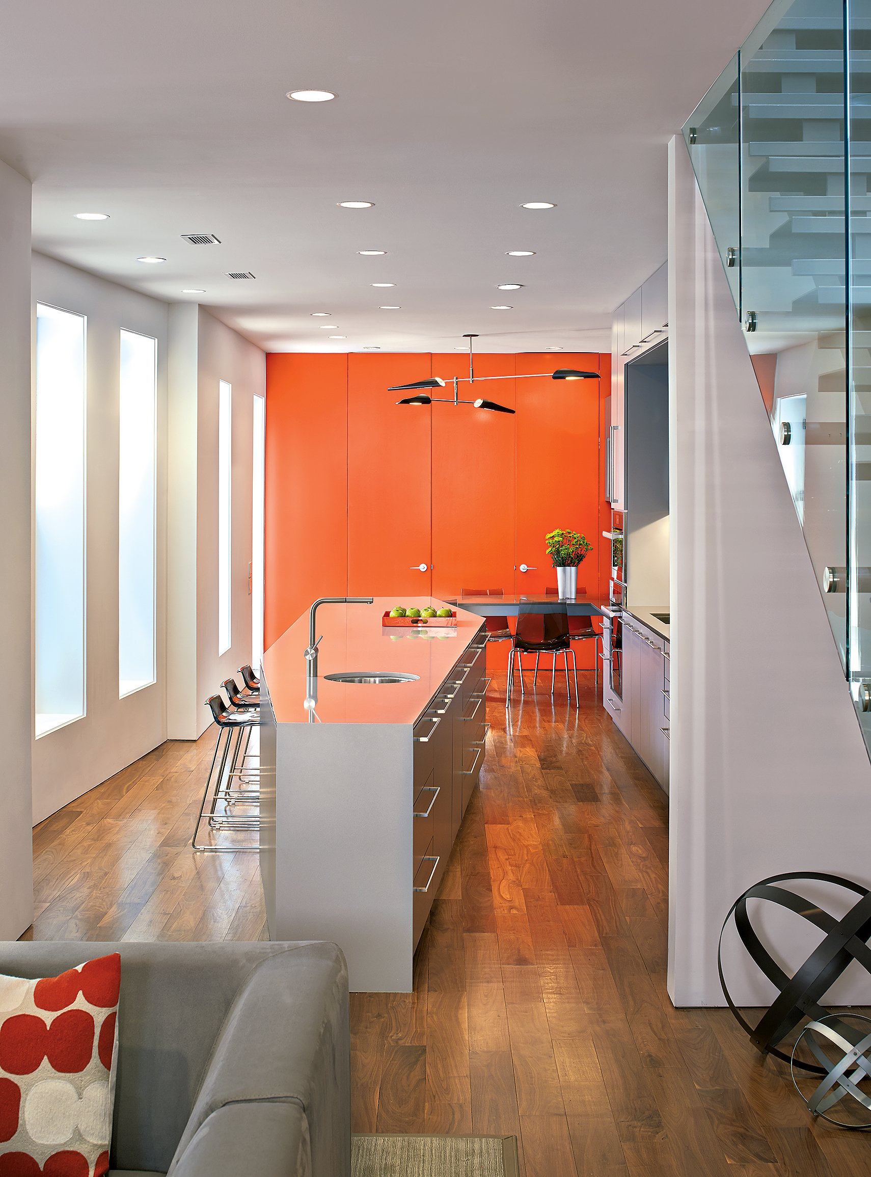 The bright back wall in this West End rowhouse designed by architect Robert Gurney includes doors to a storage-packed pantry and a powder room. Photograph by Anice Hoachlander.