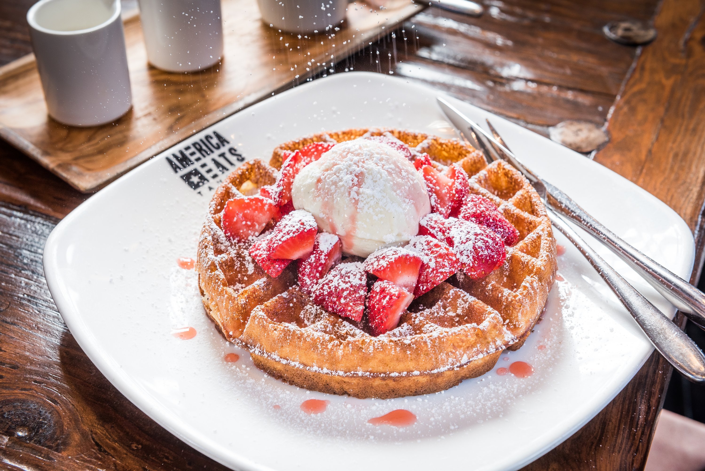 Waffles with strawberries at America Eats Tavern. Photograph by Rey Lopez. 