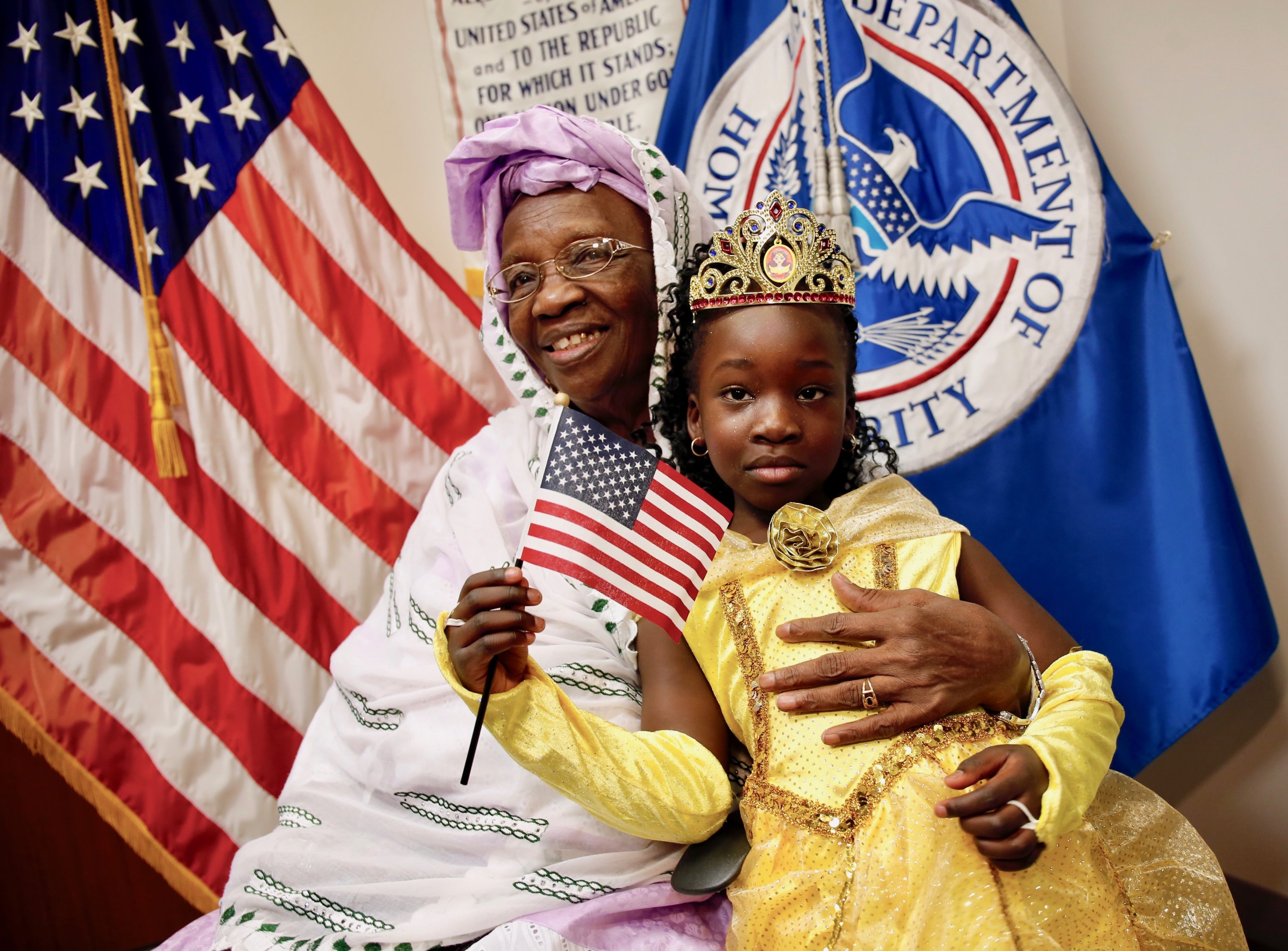 Photographs of Immigrants Becoming U.S. Citizens: A woman from Ethiopia poses with her granddaughter after she participated in a special Halloween-themed citizenship ceremony at the USCIS field office in Fairfax.