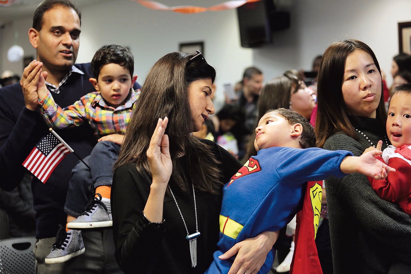 Photographs of Immigrants Becoming U.S. Citizens: US Citizenship and Immigration Services, October 31, 2018. Children being sworn in were invited to wear Halloween costumes and trick-or-treat in the office.