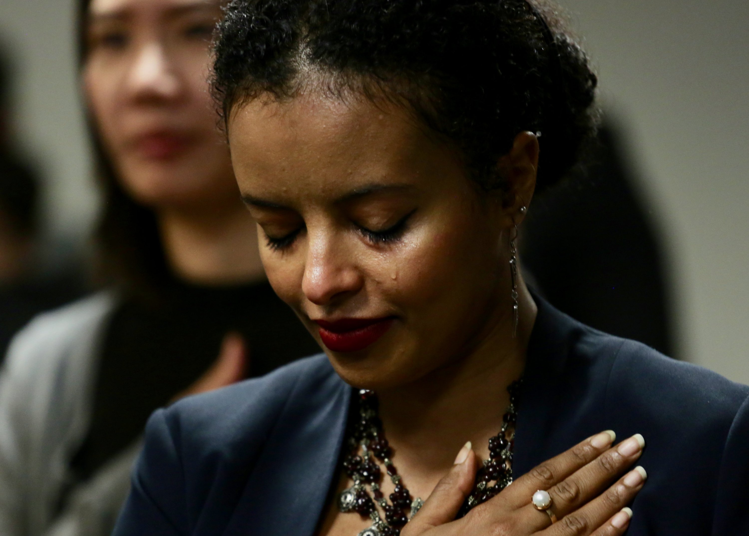 Photographs of Immigrants Becoming U.S. Citizens: A newly minted U.S. citizen during the Oath of Allegiance during a naturalization ceremony at the USCIS field office in Fairfax.