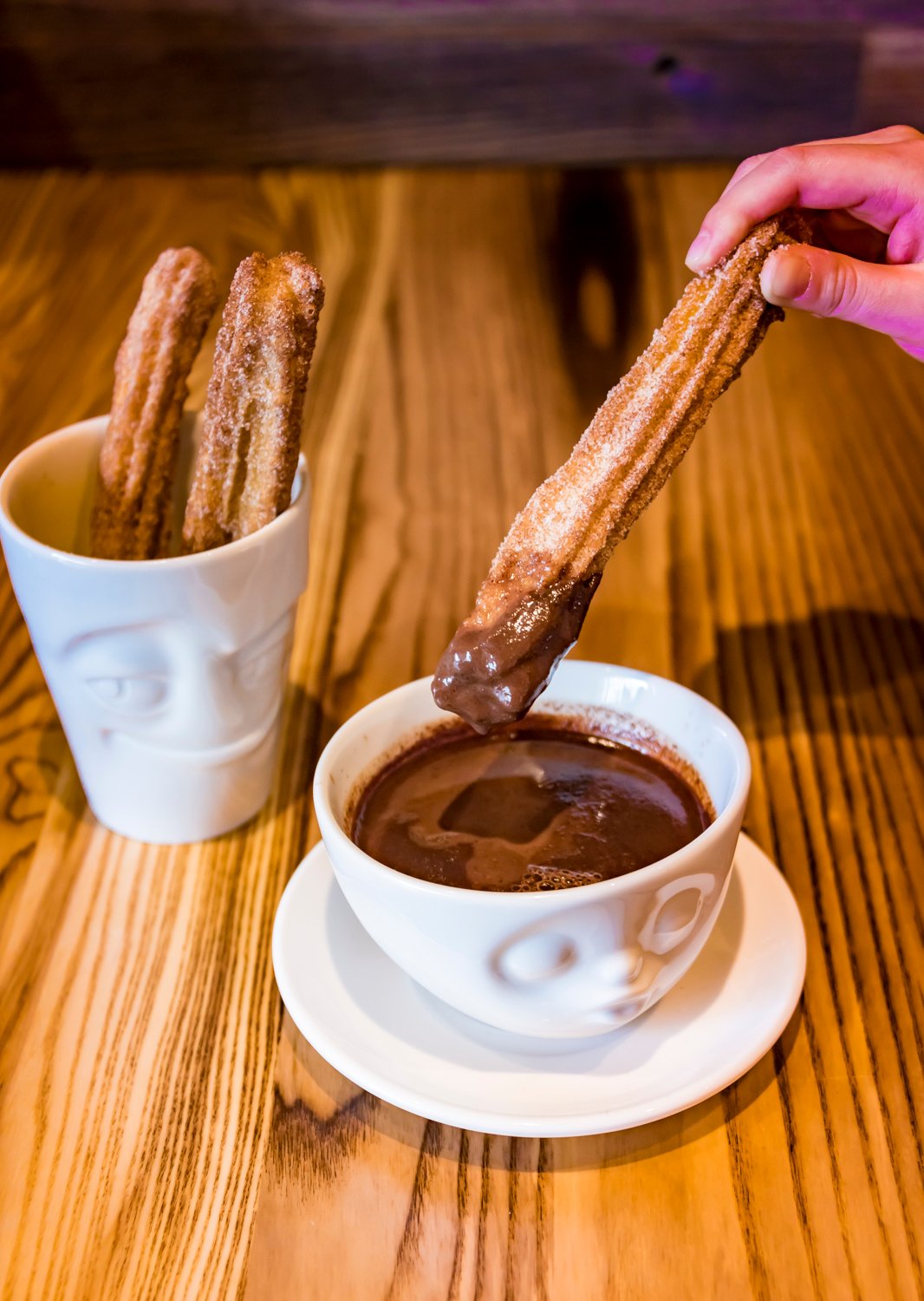 Dip churros into chocolate for dessert.