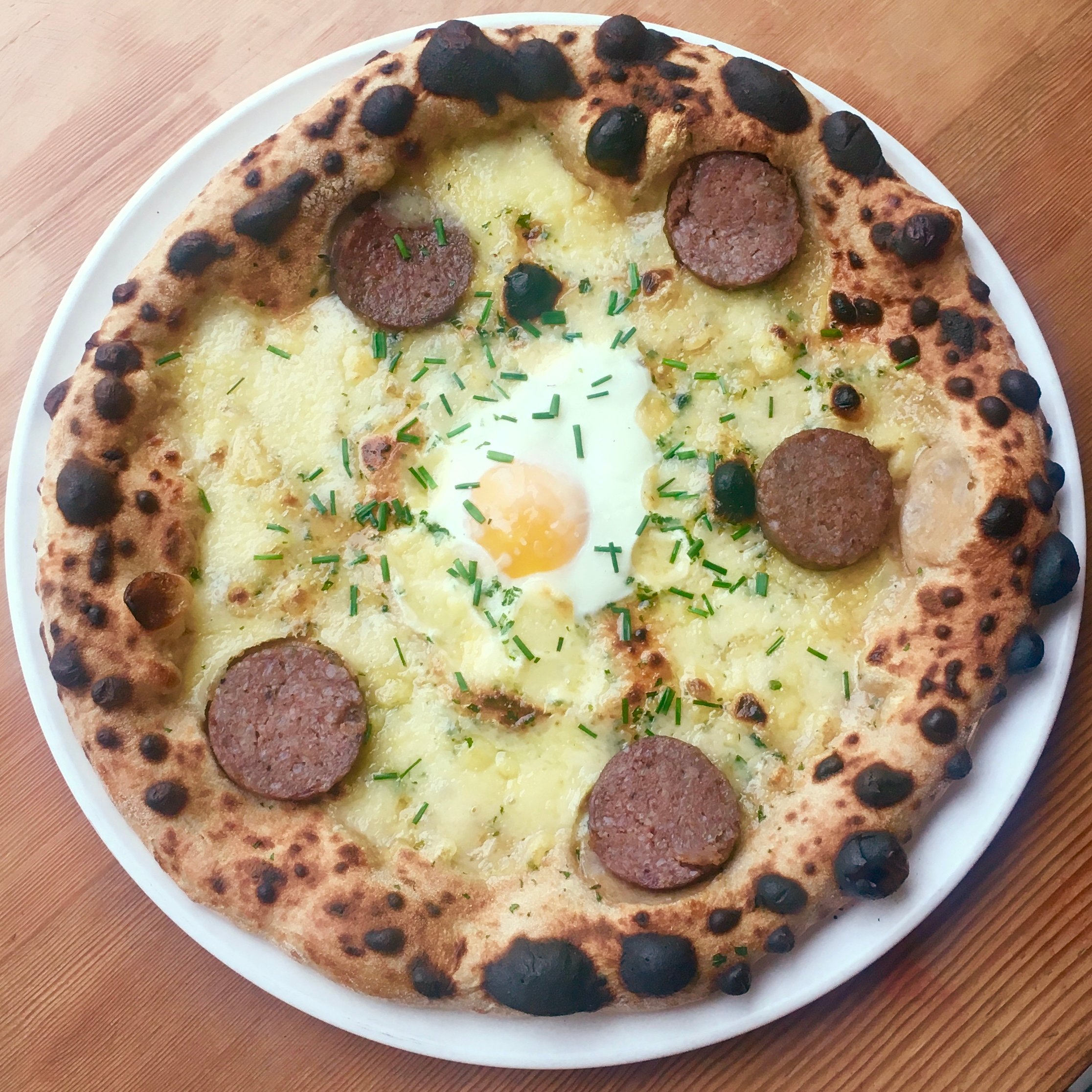 Etto Cotechino with Fontina and Egg - Washingtonian Etto's pizza pairs sausage and egg with fontina cheese. Photograph courtesy of Etto.