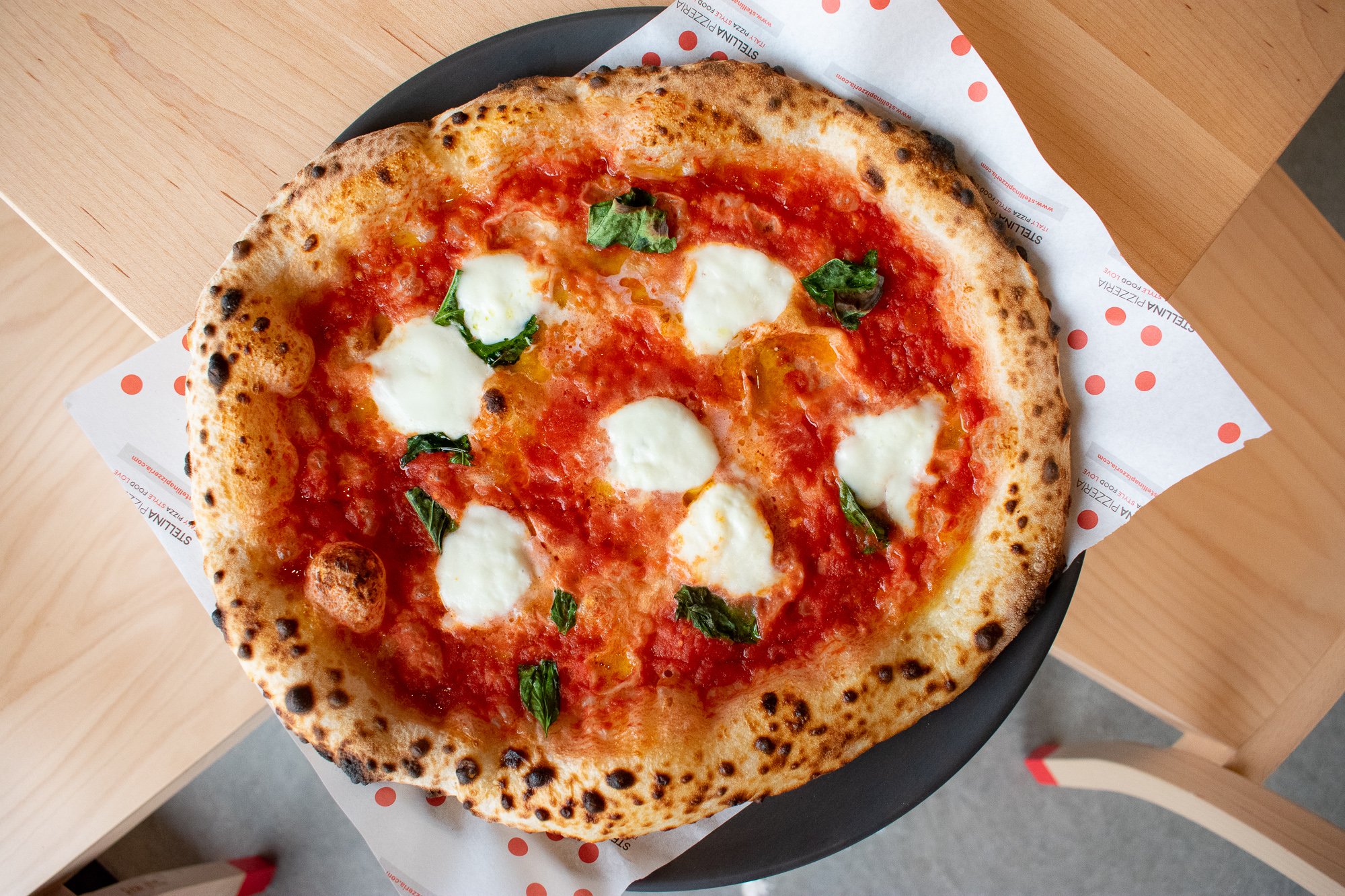 Mozzarella, tomato, and basil top the classic Margarita pizza. Photograph by Meaghan Webster. 