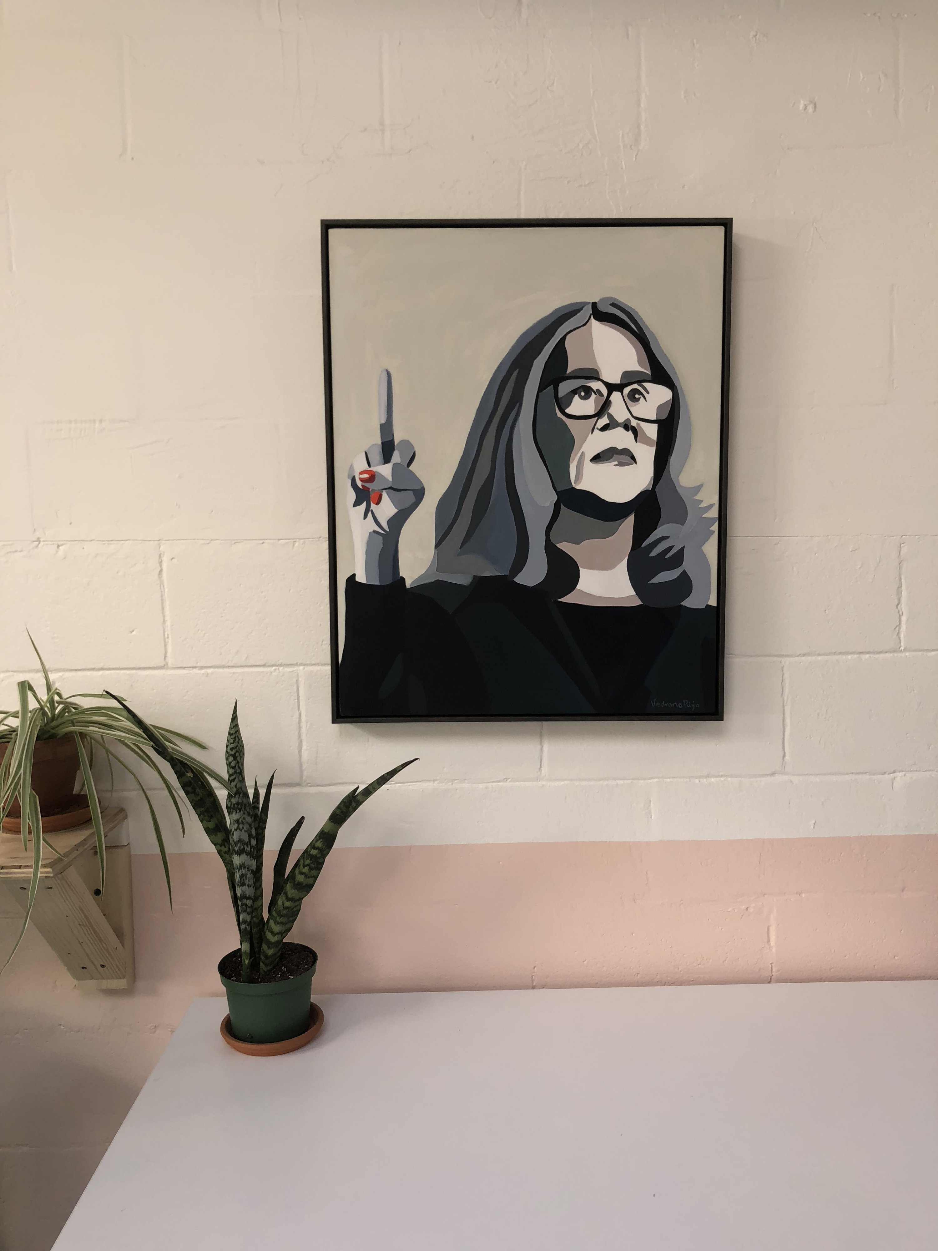 A painting of Christine Blasey Ford hangs on the wall. 