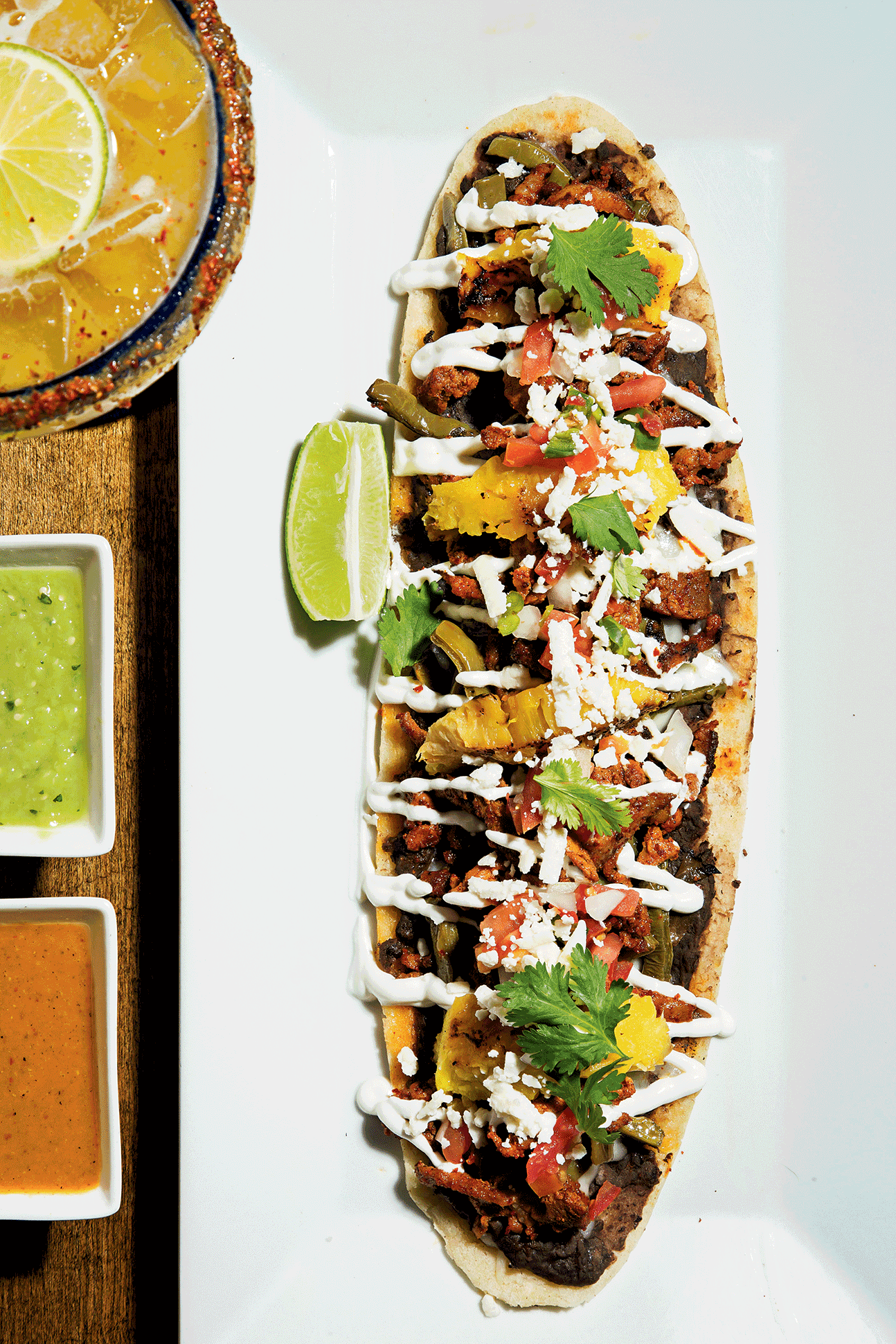 The huarache—a masa cake topped with beans, sour cream, and al pastor–style pork—at Mezcalero. The huarache—a masa cake topped with beans, sour cream, and al pastor–style pork—at Mezcalero.