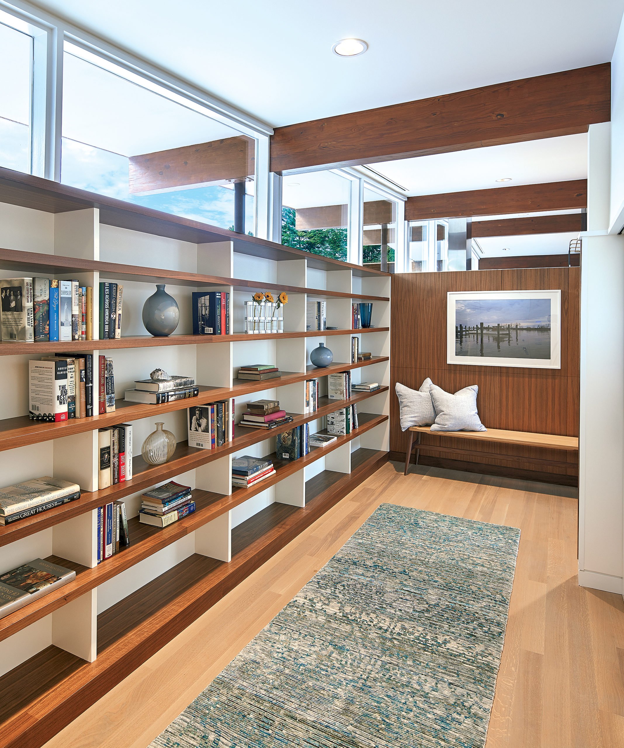 The architects added built-in shelves to the entryway, further emphasizing the clerestory windows above them.