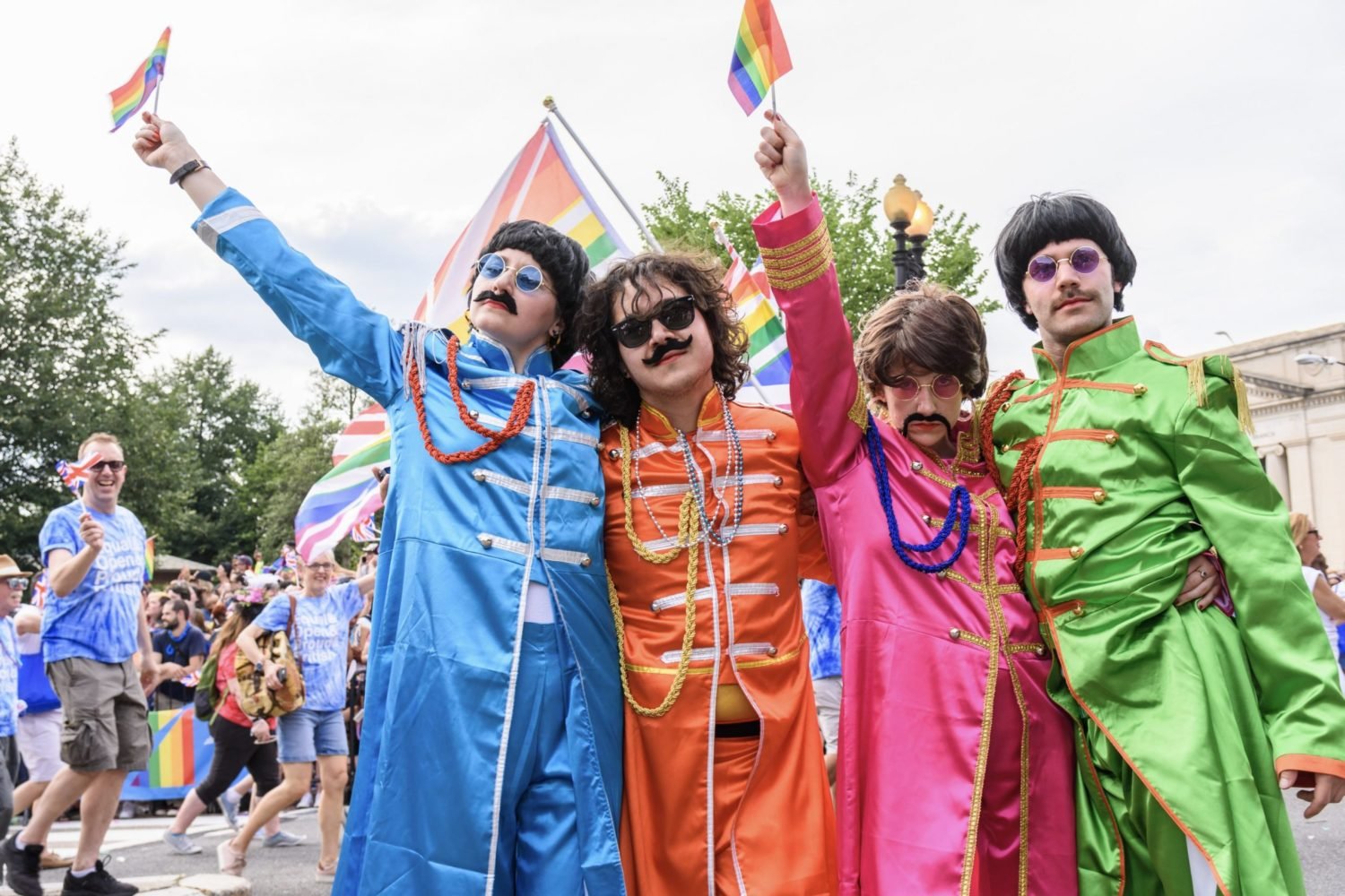 Embassy volunteers dressed as the Beatles wave rainbow flags during the Capital Pride Parade. Photo by Scott Marder.