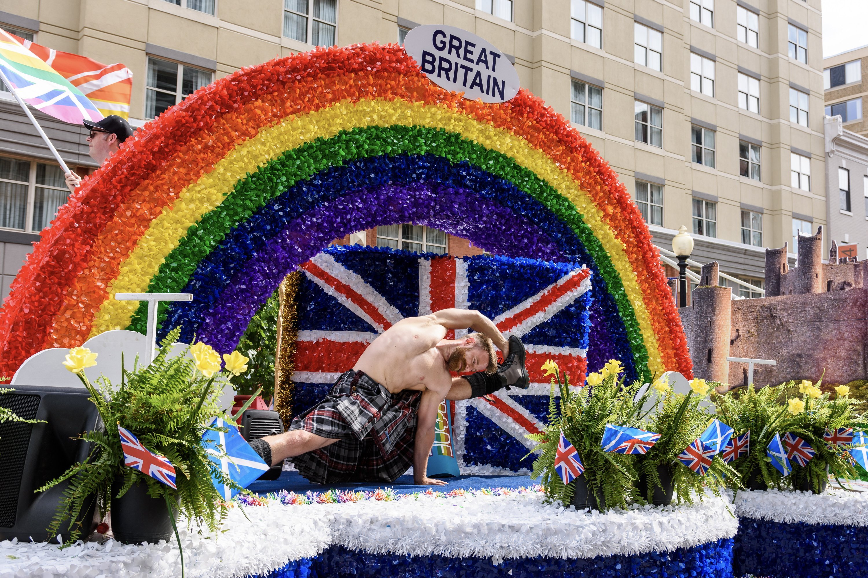 Pride Parade 2019-5 - Washingtonian Scottish influencer Finley Wilson strikes a yoga pose in a kilt on the embassy float. Photograph by Scott Marder.