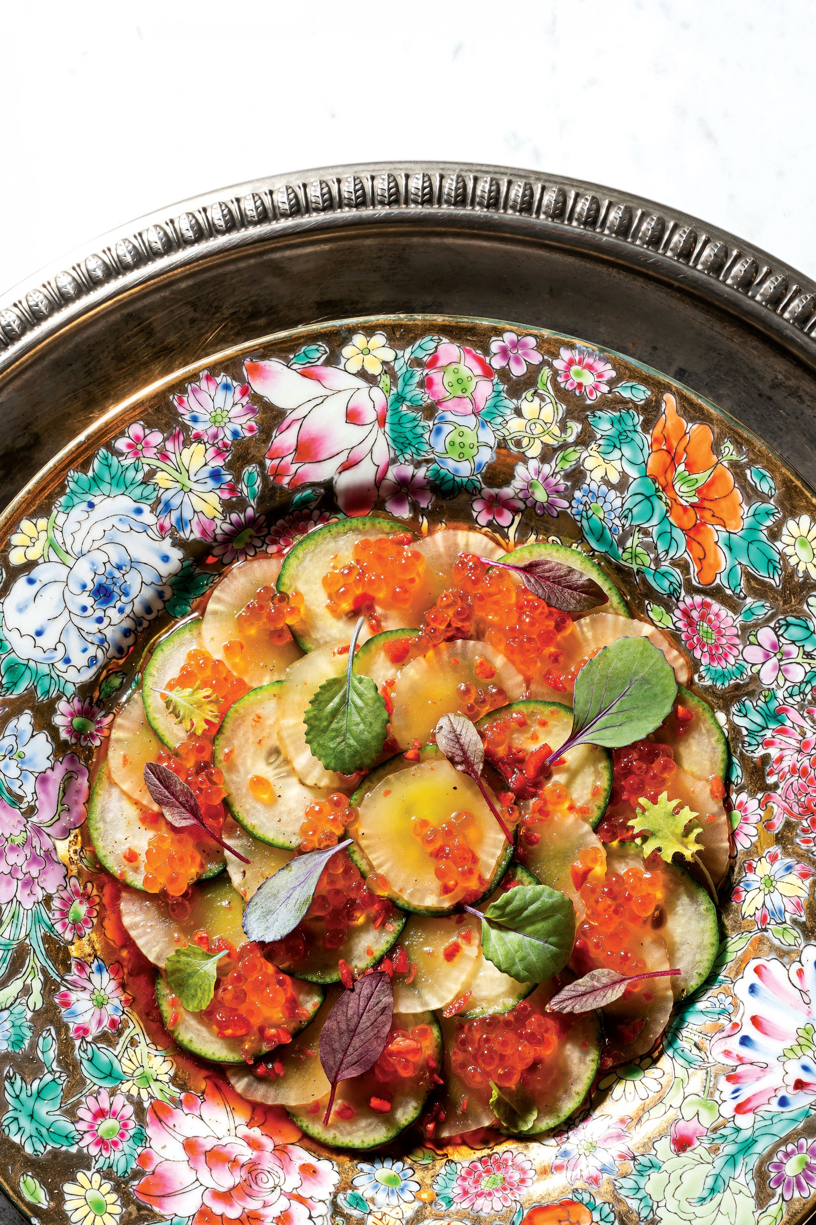 QUEENSENGLISH_0010.FULL_ALT - Washingtonian Cheung's version of a cucumber salad made with sesame oil and red vinegar, then strewn with flower petals. Photograph by Scott Suchman.