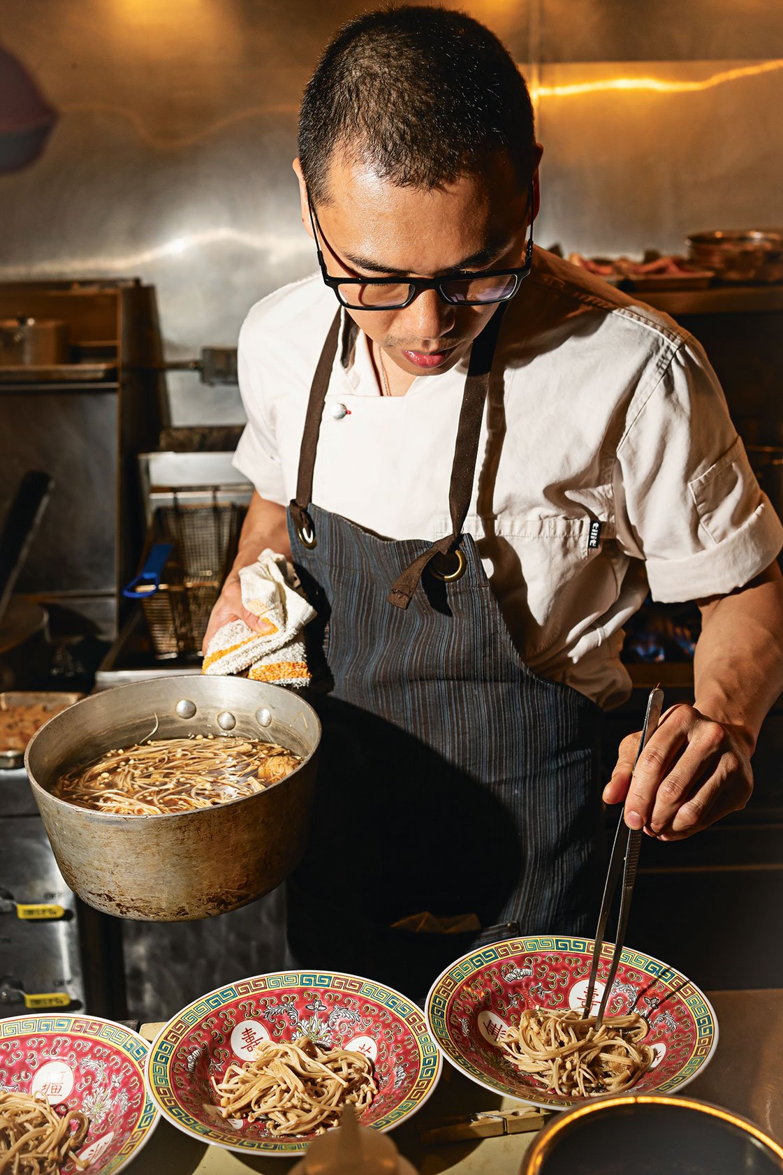 QUEENSENGLISH_0058.QTR - Washingtonian Cheung braises enoki mushrooms in a barrel-aged soy sauce infused with garlic, ginger, and prickly-ash berry. Photograph by Scott Suchman.