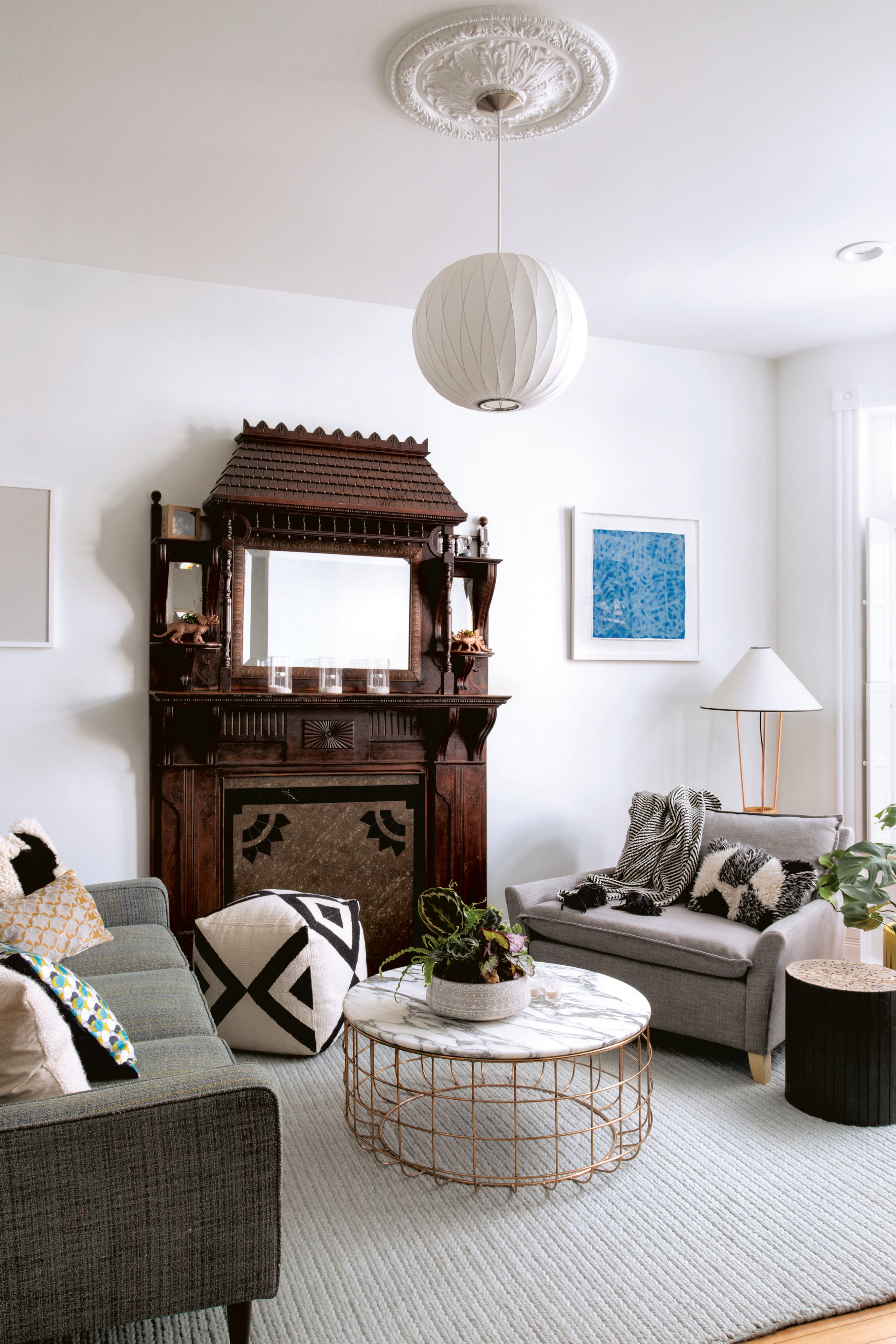 Creating contrast: Designer Nicole Lanteri chose clean-lined living-room furniture that doesn’t compete with the intricate 19th-century mantle. Photograph by Jenn Verrier Photography.