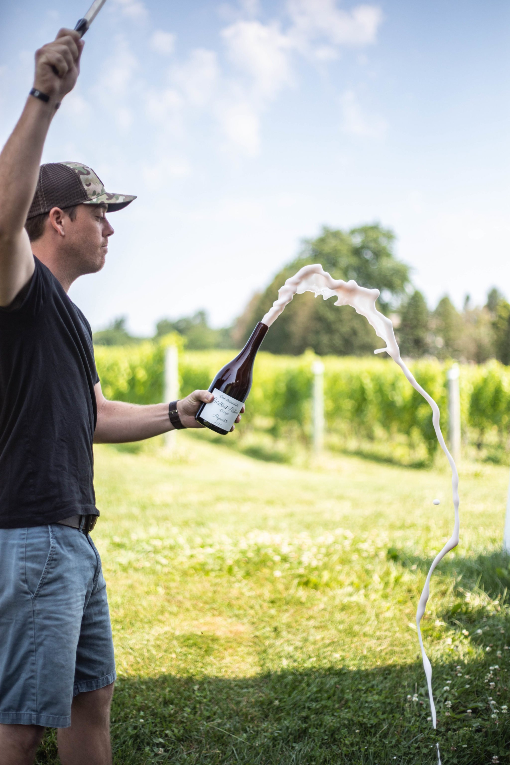 Old Westminster Winery's vigneron Drew Baker opens a bottle of piquette. Photo courtesy of Old Westminster Winery.