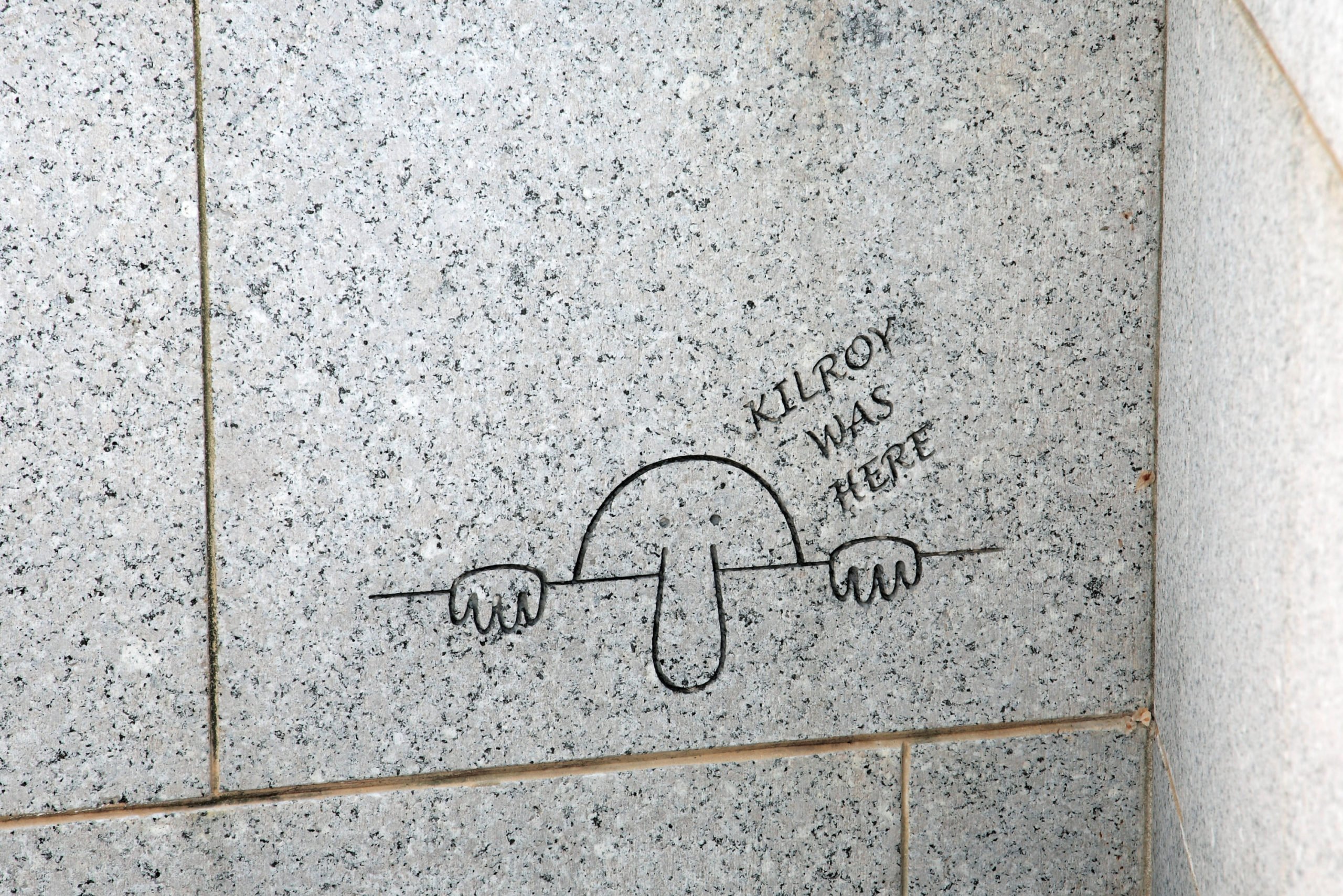 One of two Kilroy graffiti engravings on the World War II Memorial in Washington, DC - Washingtonian