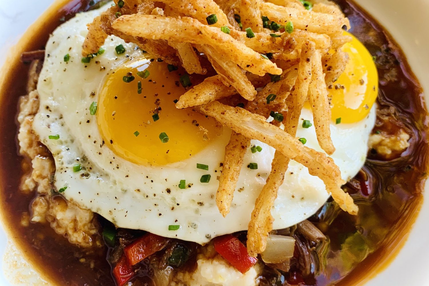 Egg-topped grits and grillades at Pearl Dive. Photo courtesy of Pearl Dive.