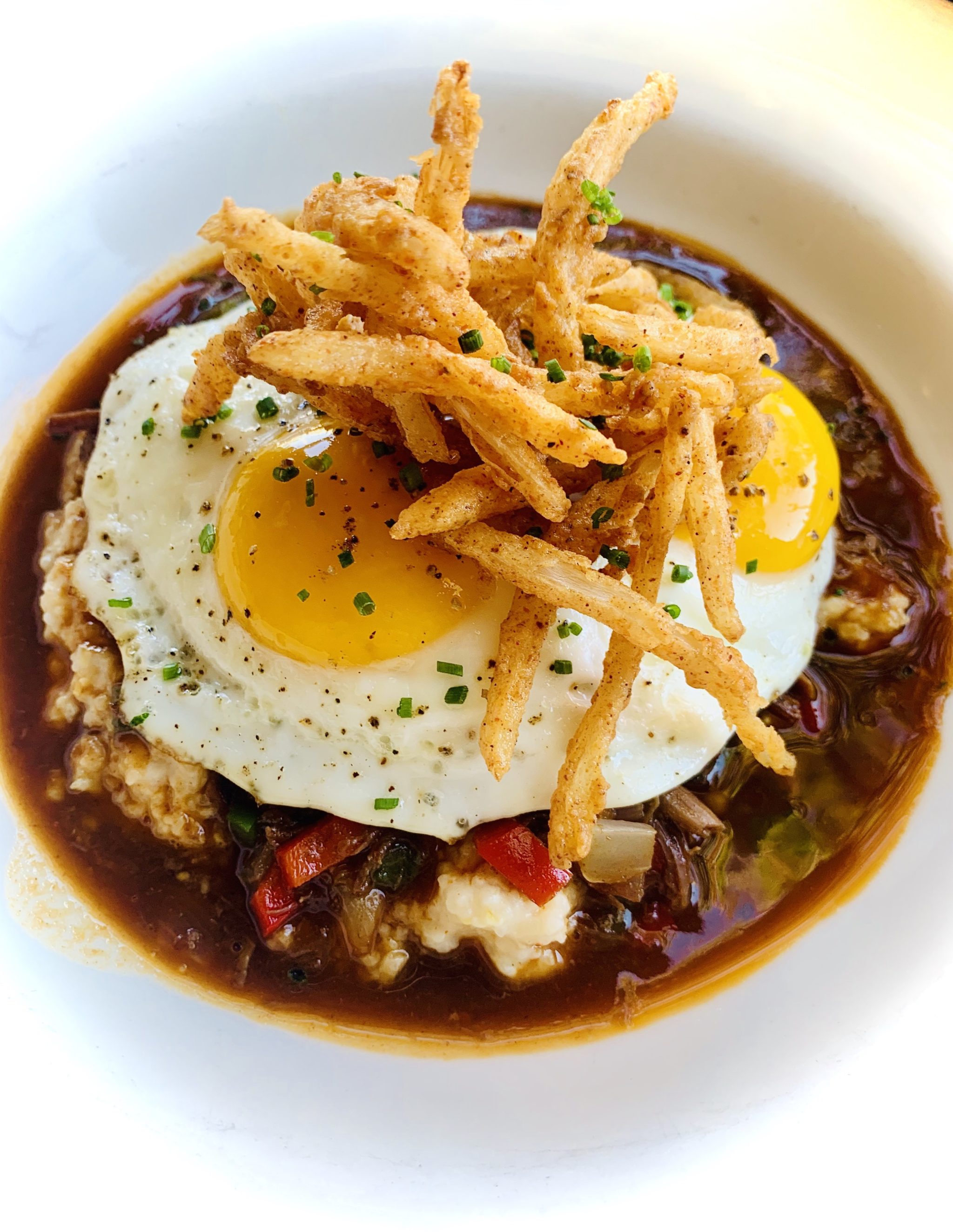 Egg-topped grits and grillades at Pearl Dive. Photo courtesy of Pearl Dive.